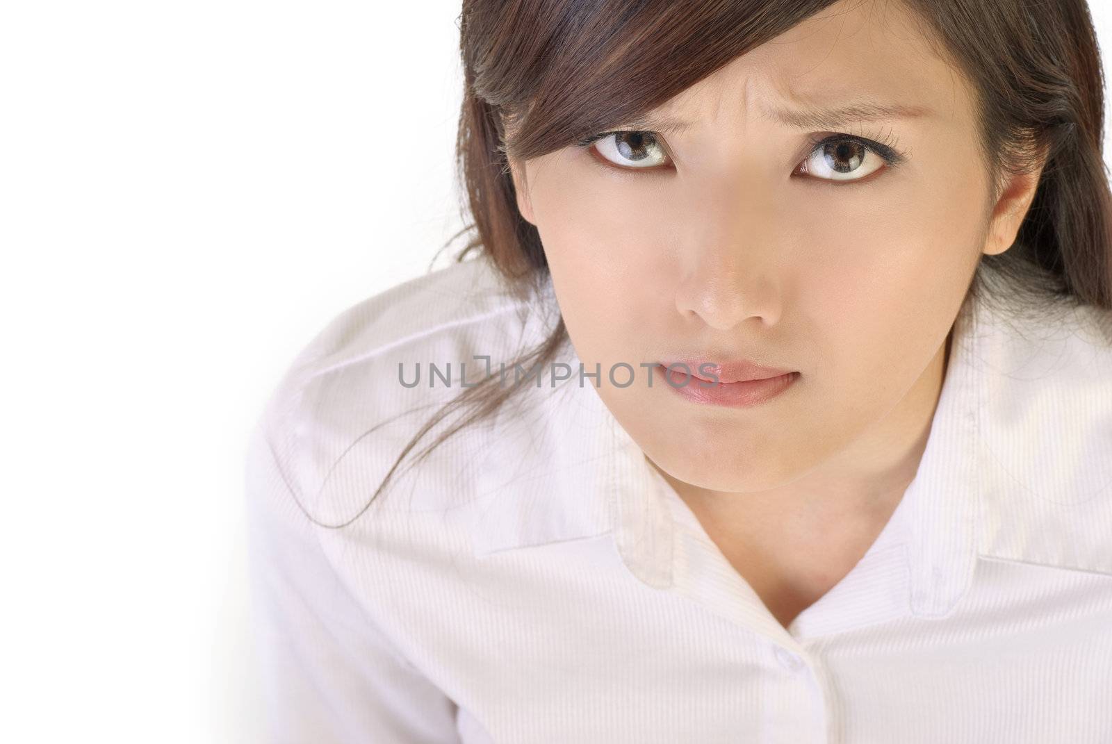 Angry expression of Asian businesswoman on white background.