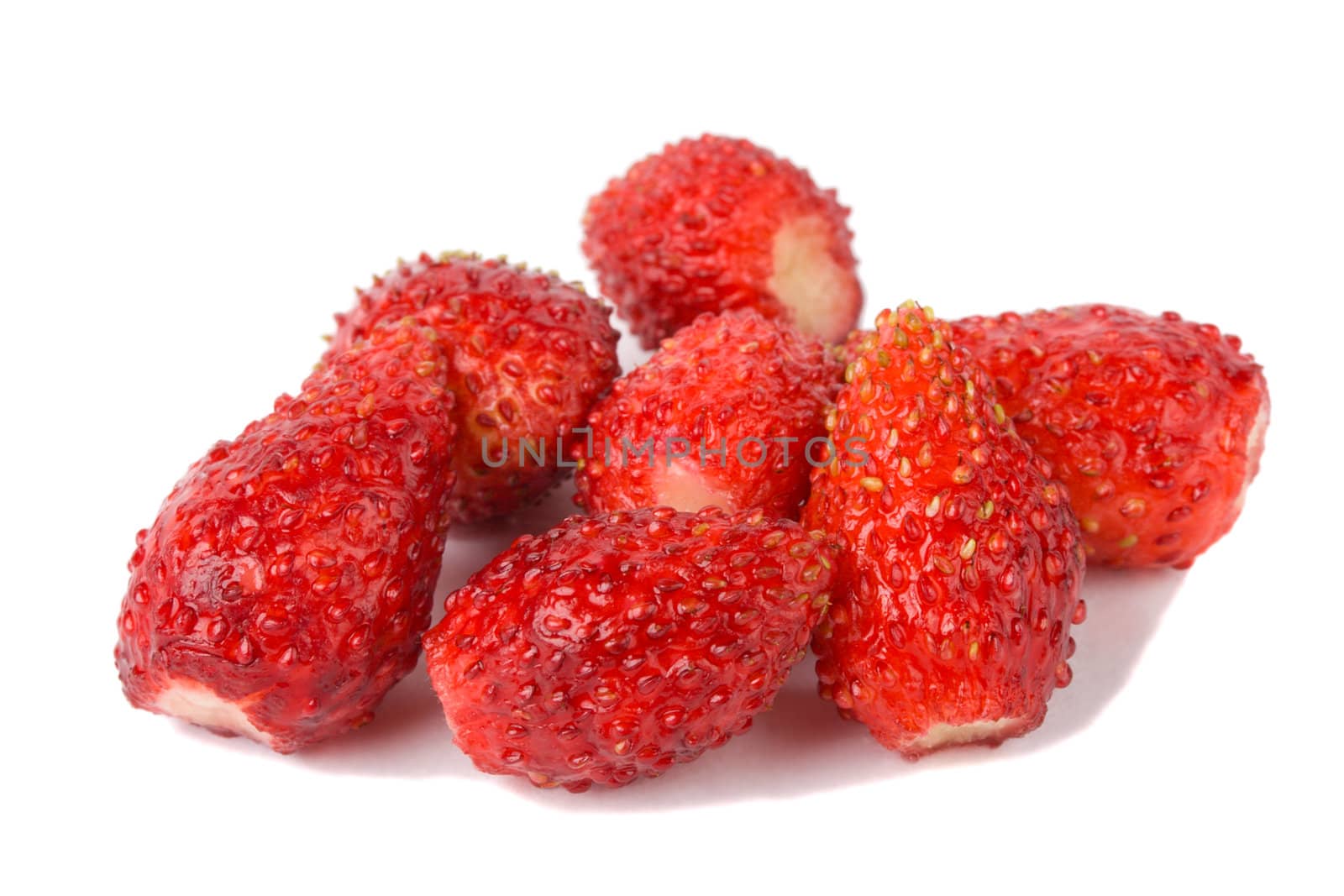 close-up heap of wild strawberries, isolated on white