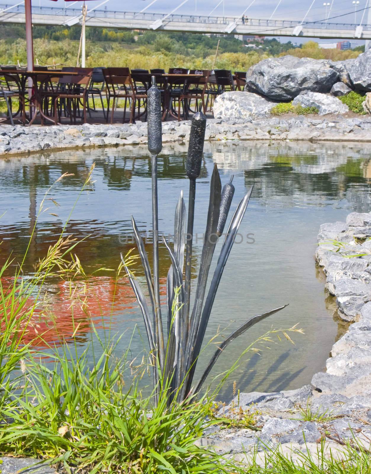 The image of a metal cane among a usual grass