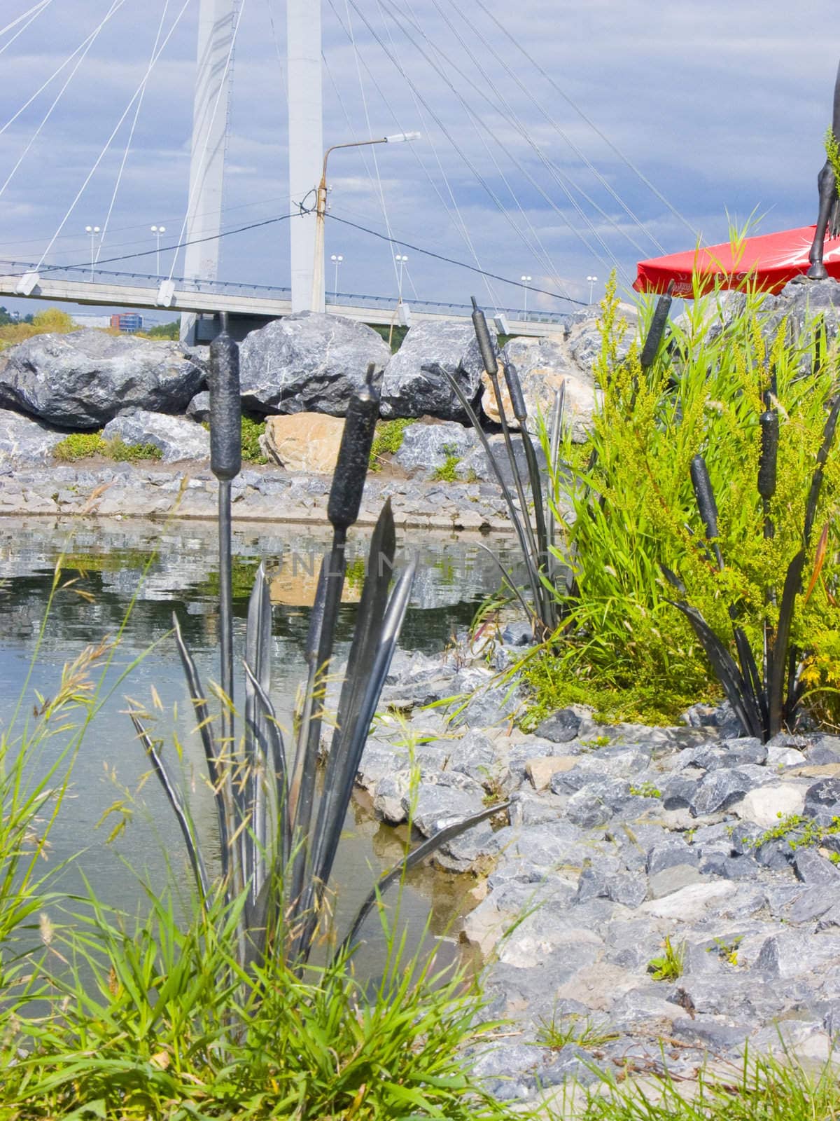 The image of a metal cane among a usual grass