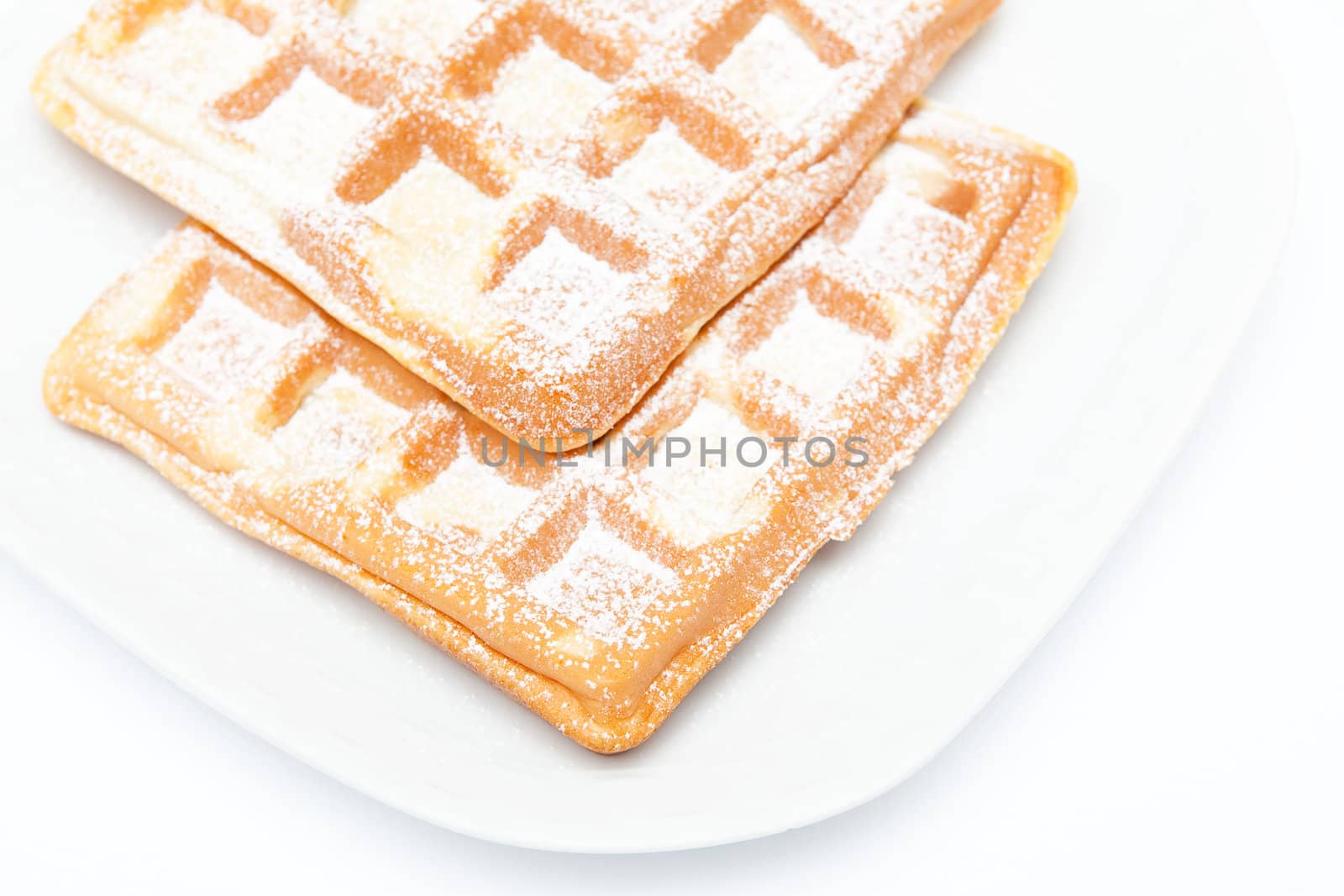 Two waffles on the white plate