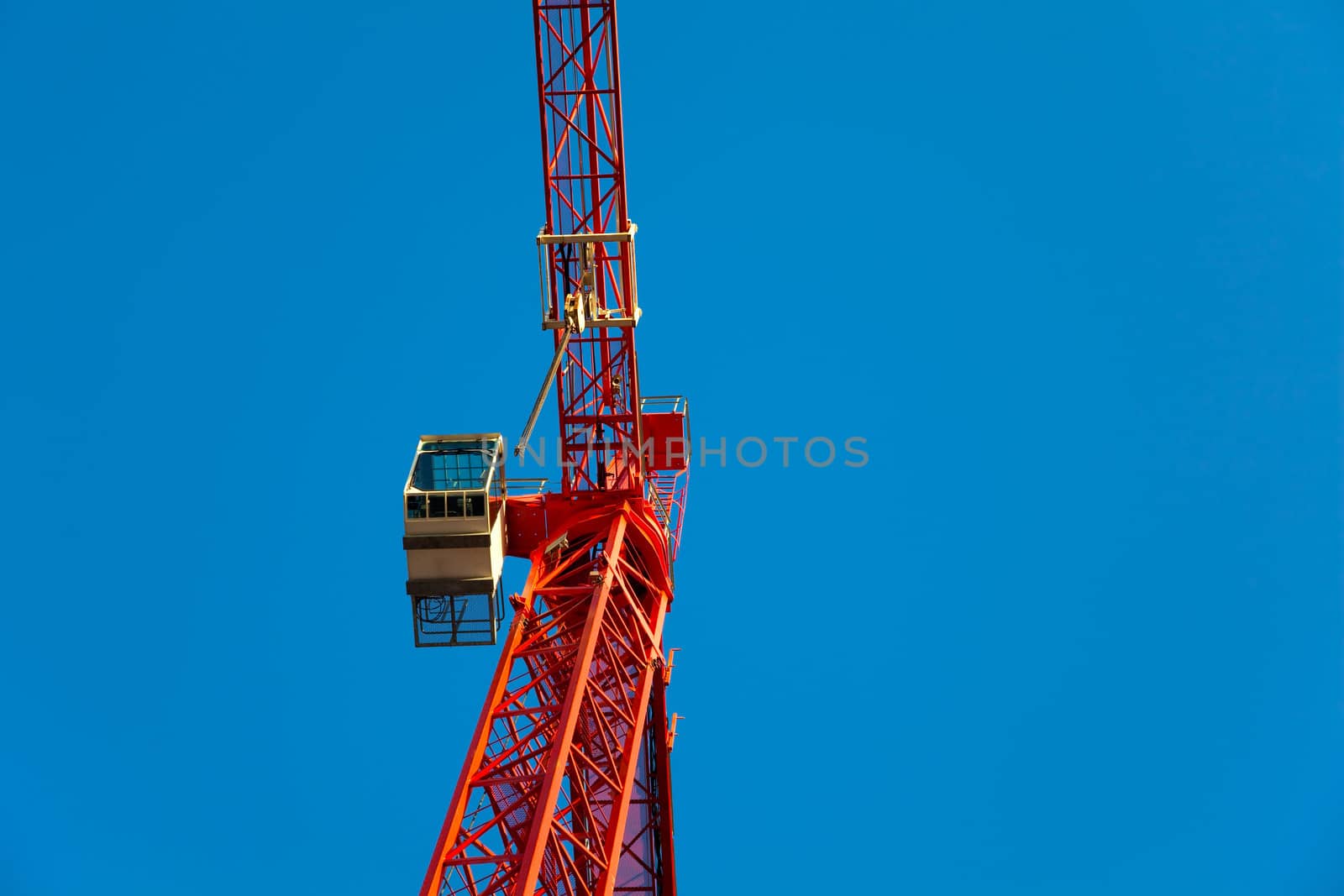 Red crane against blue sky.