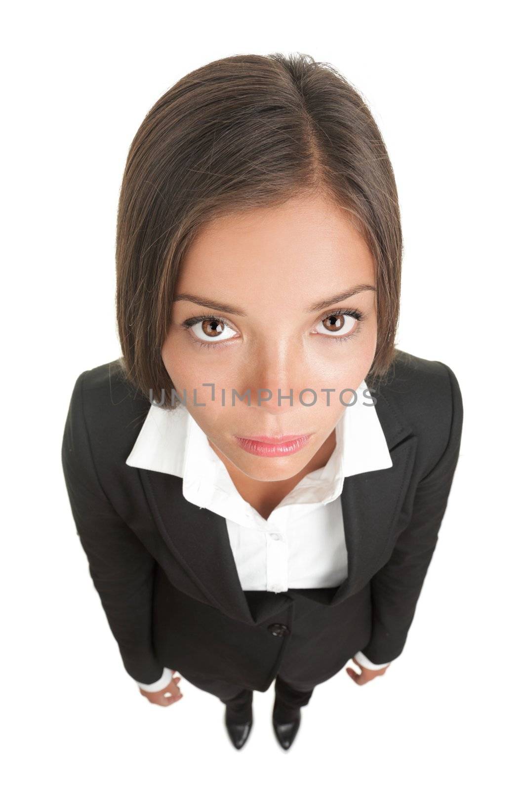 Bored sad businesswoman isolated. Funny image of a young woman with a dull look staring at the camera. High angle view with near fish-eye effect. Isolated on white background.