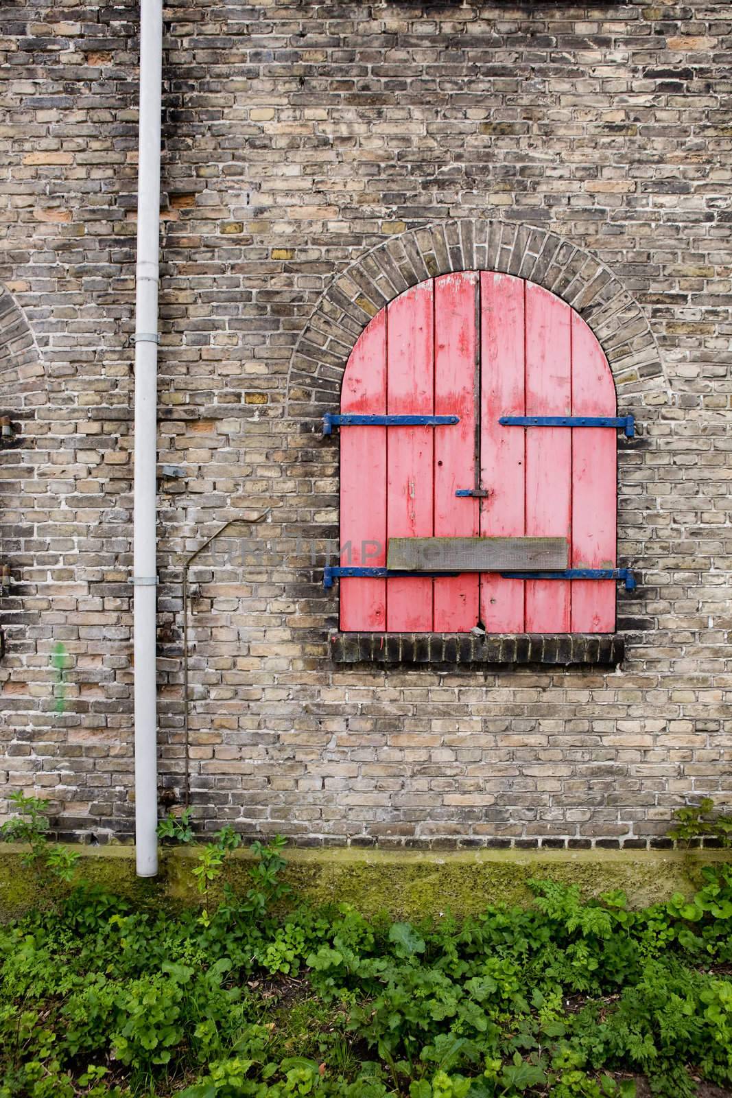 An old antique window on a brick building