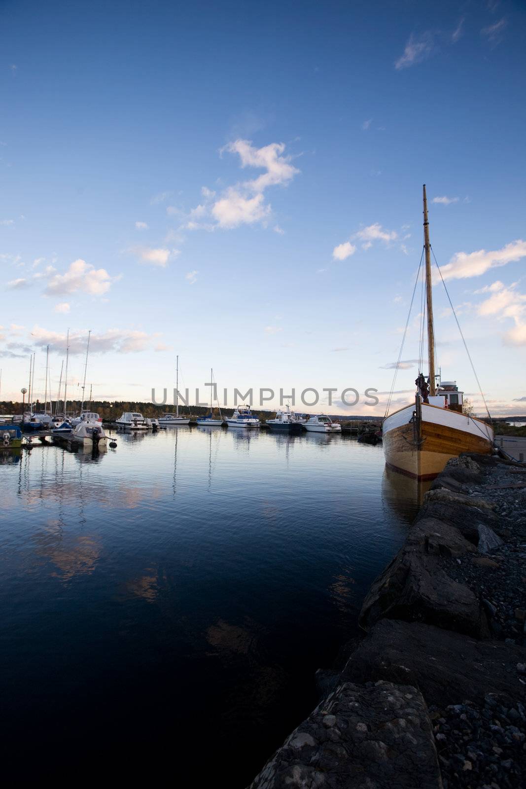 A dock with sailboats in the evening sun