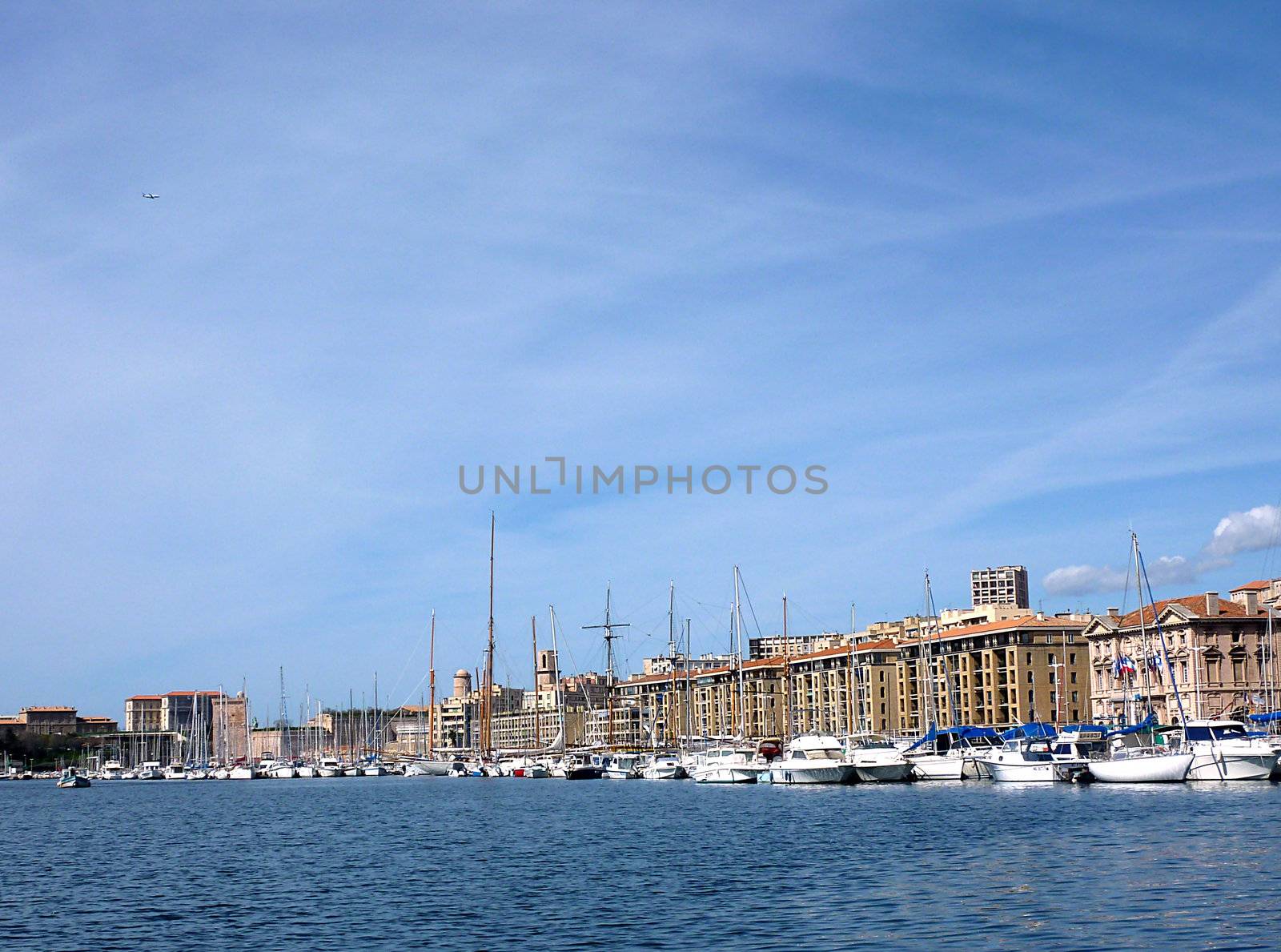 Old port of Marseilles with buildings, boats and Mediterranean sea by beautiful weather