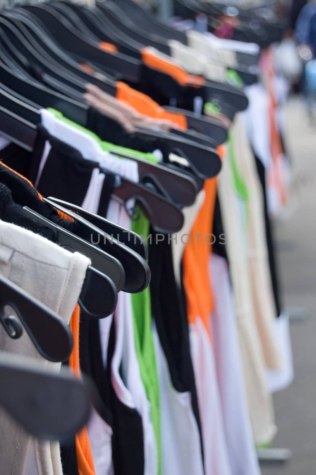 shirts hanging in a row on market