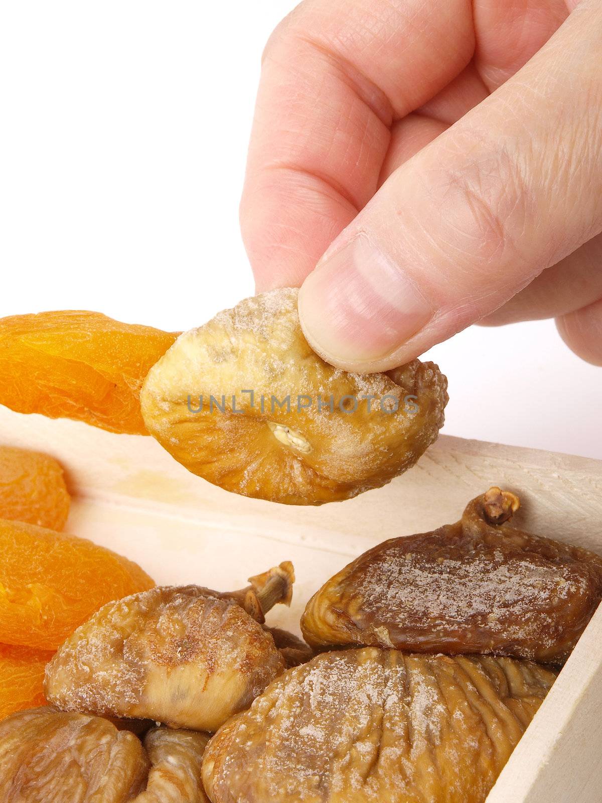 Hand taking a dried fruit