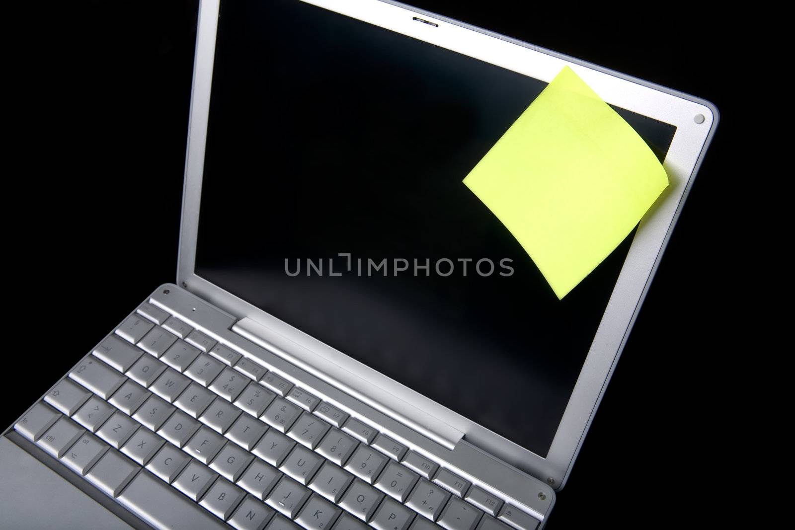 A sticky note on a laptop computer - remember this