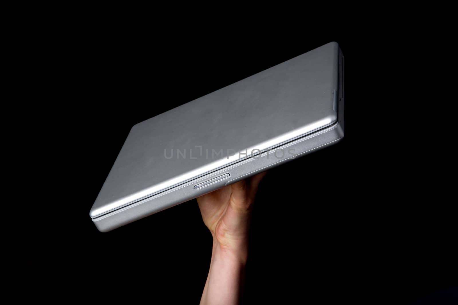 A handholding a small laptop computer with a blank screen.