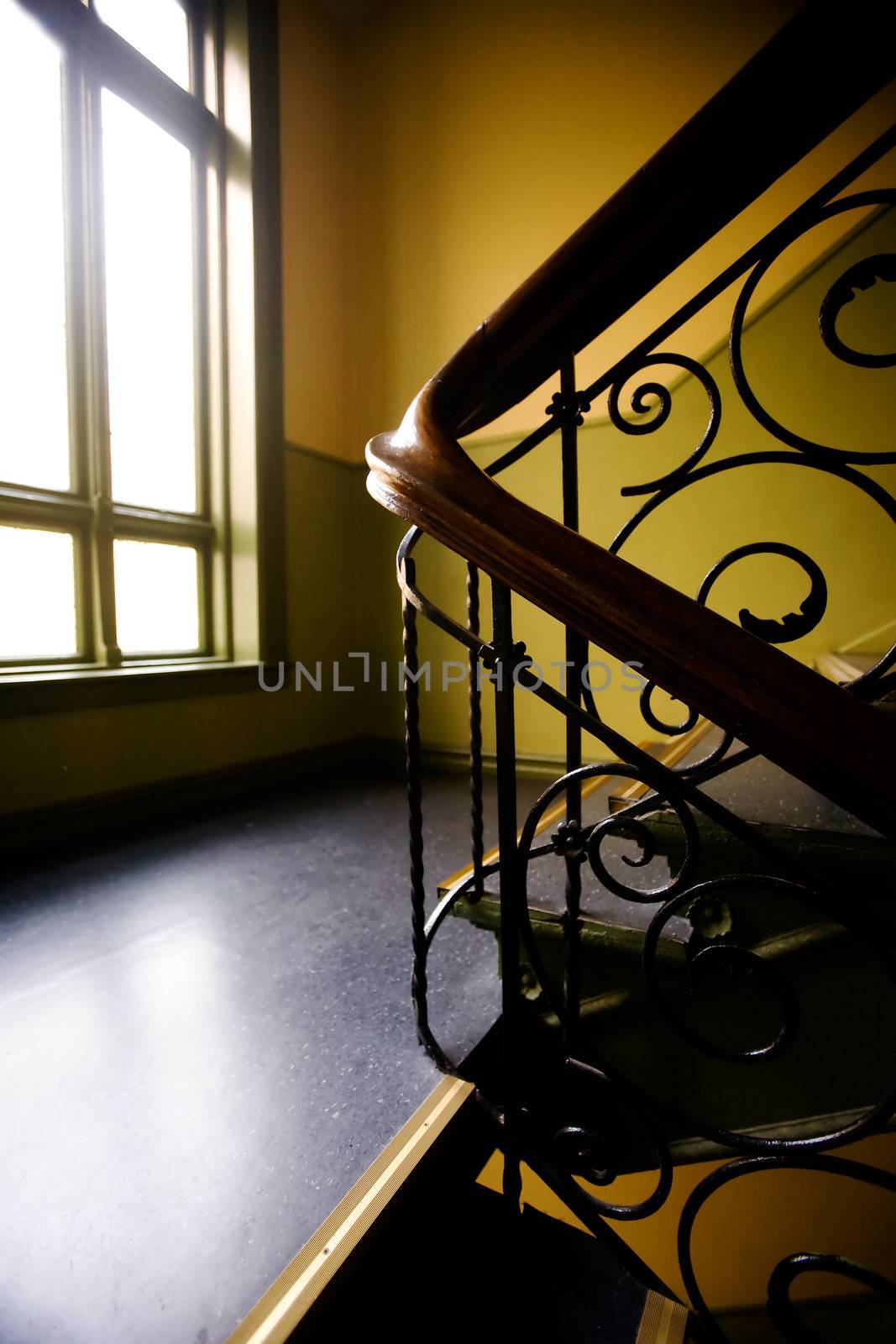 A staircase with a art nouveaux banister