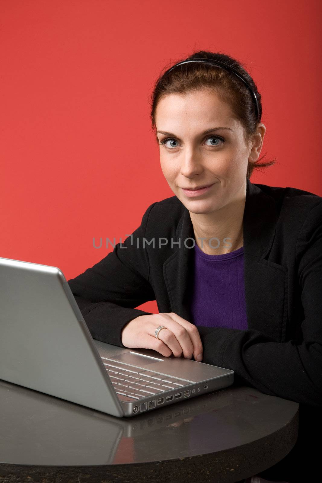 Young Woman using Laptop by leaf