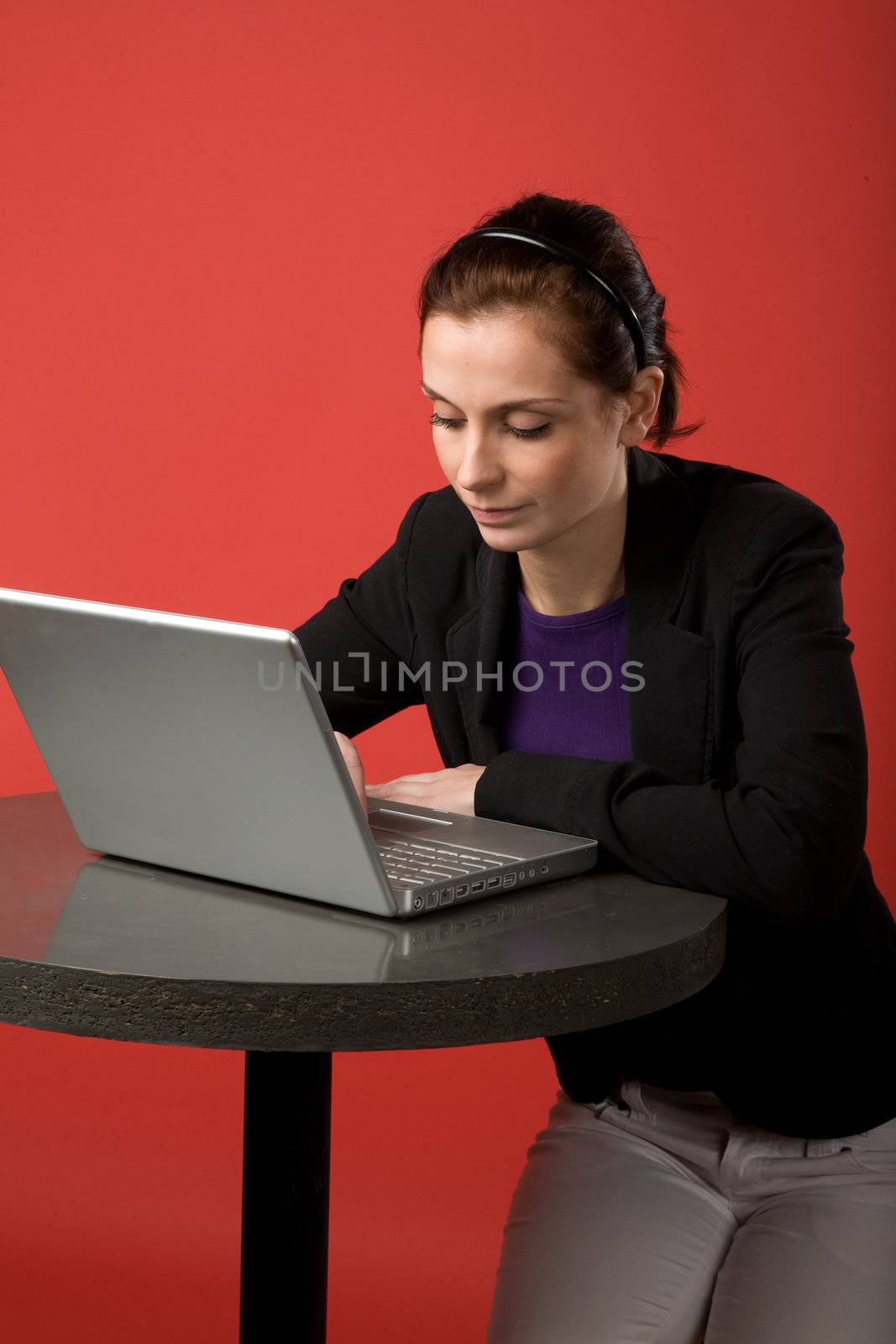 Young Woman using Laptop by leaf