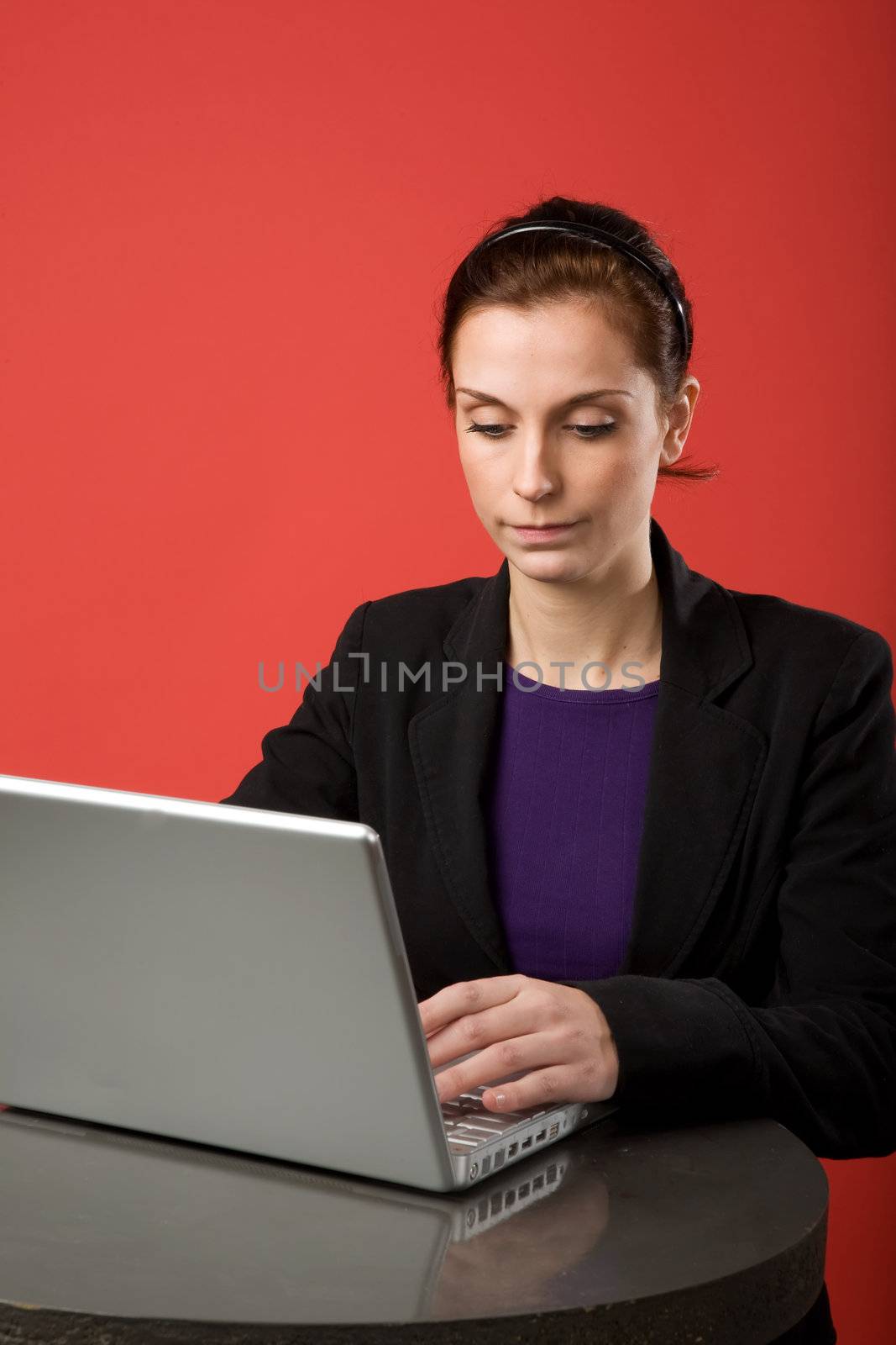 A young woman working on a latptop computer