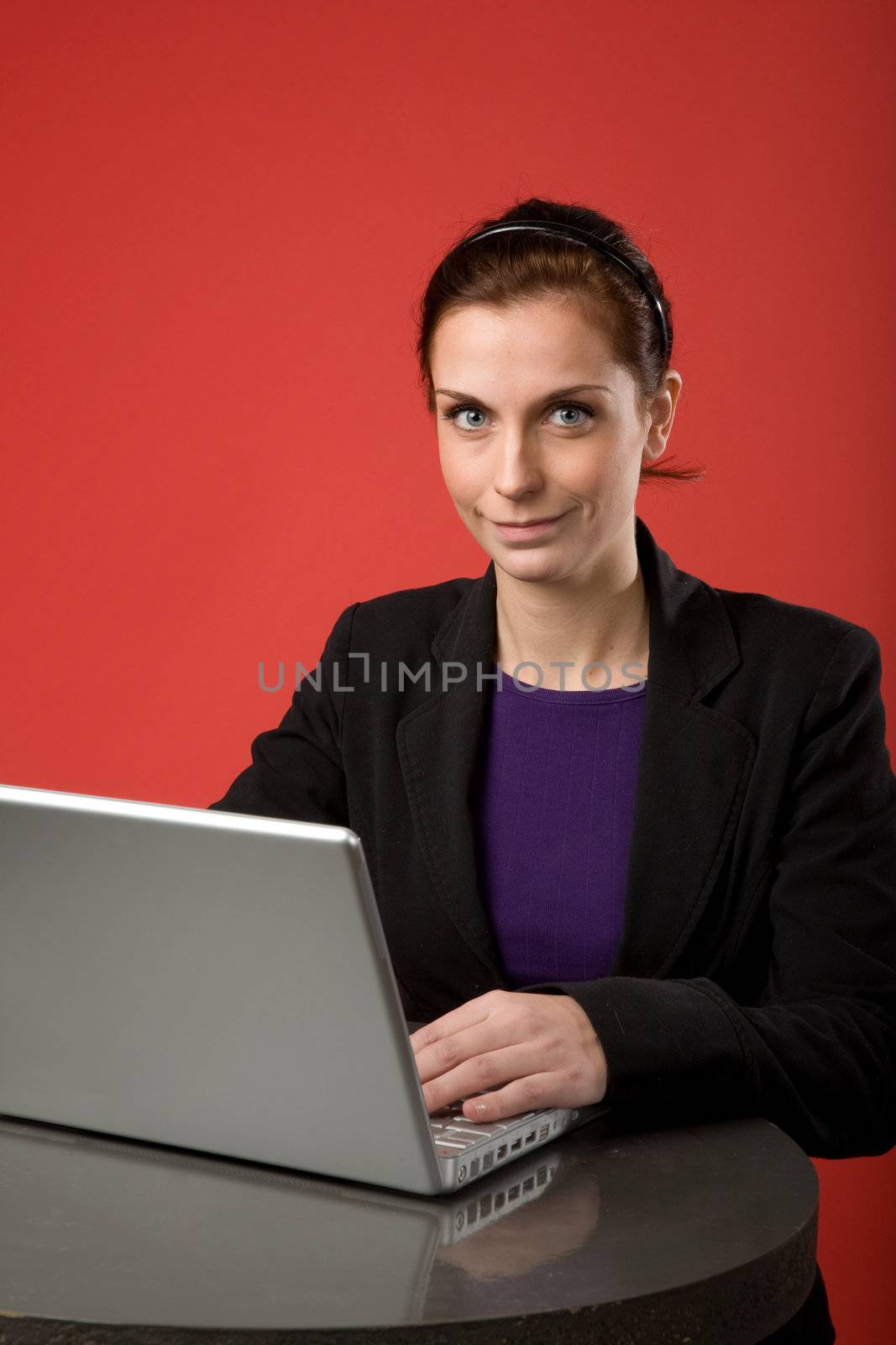 Young Woman using Laptop by leaf