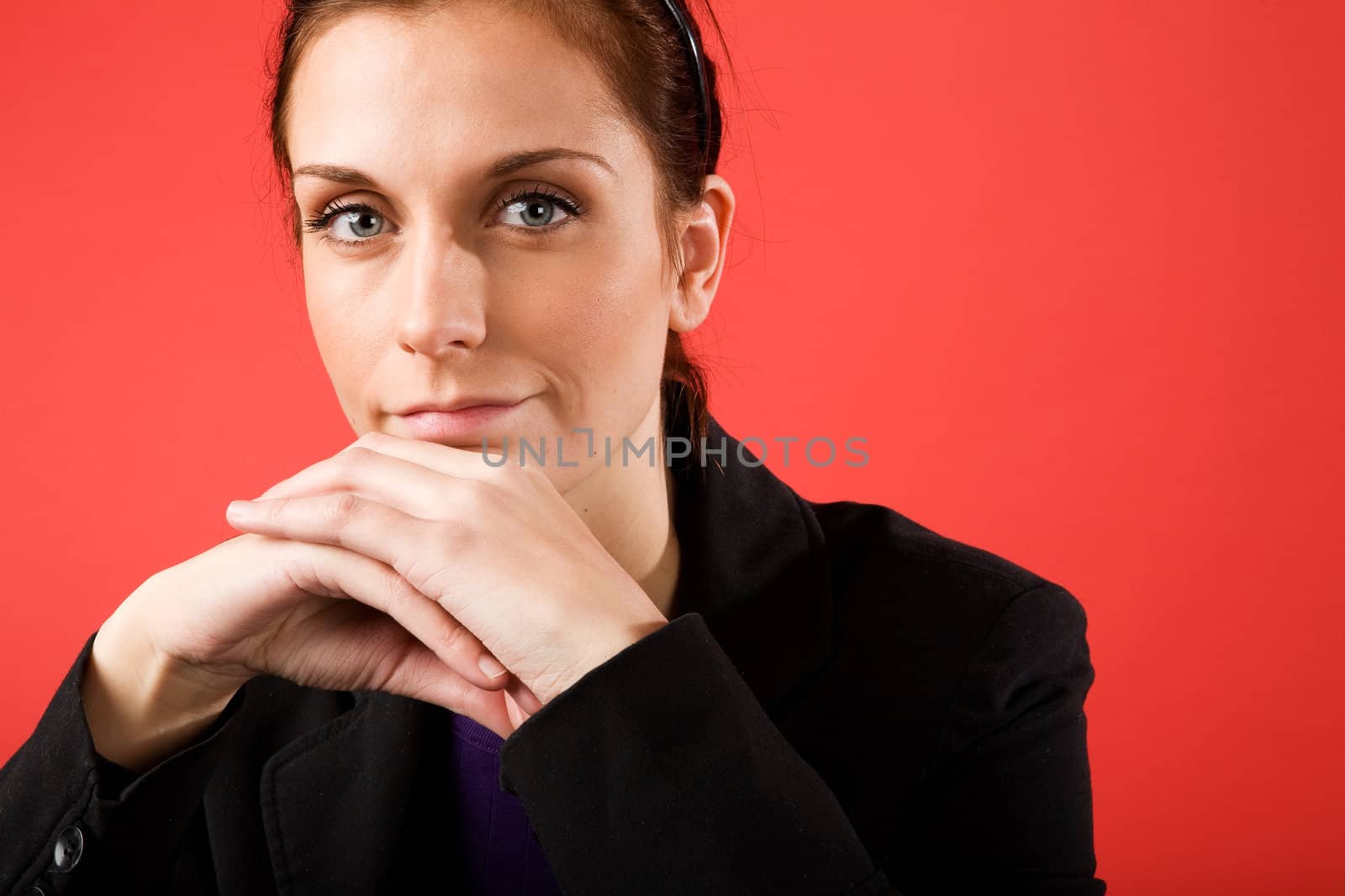 A young content business woman looks at the camera