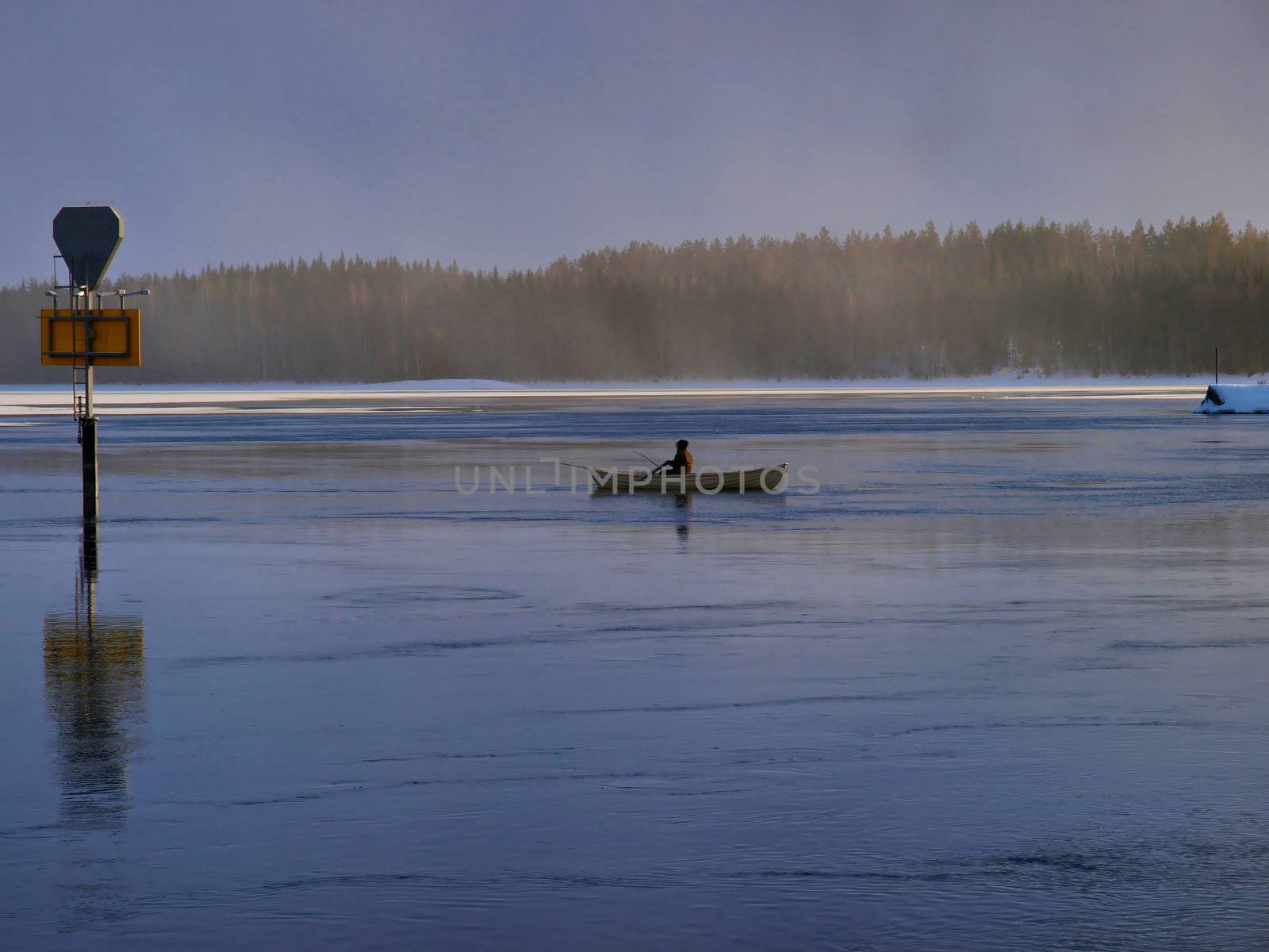 Small fishing boat on a lake by dotweb