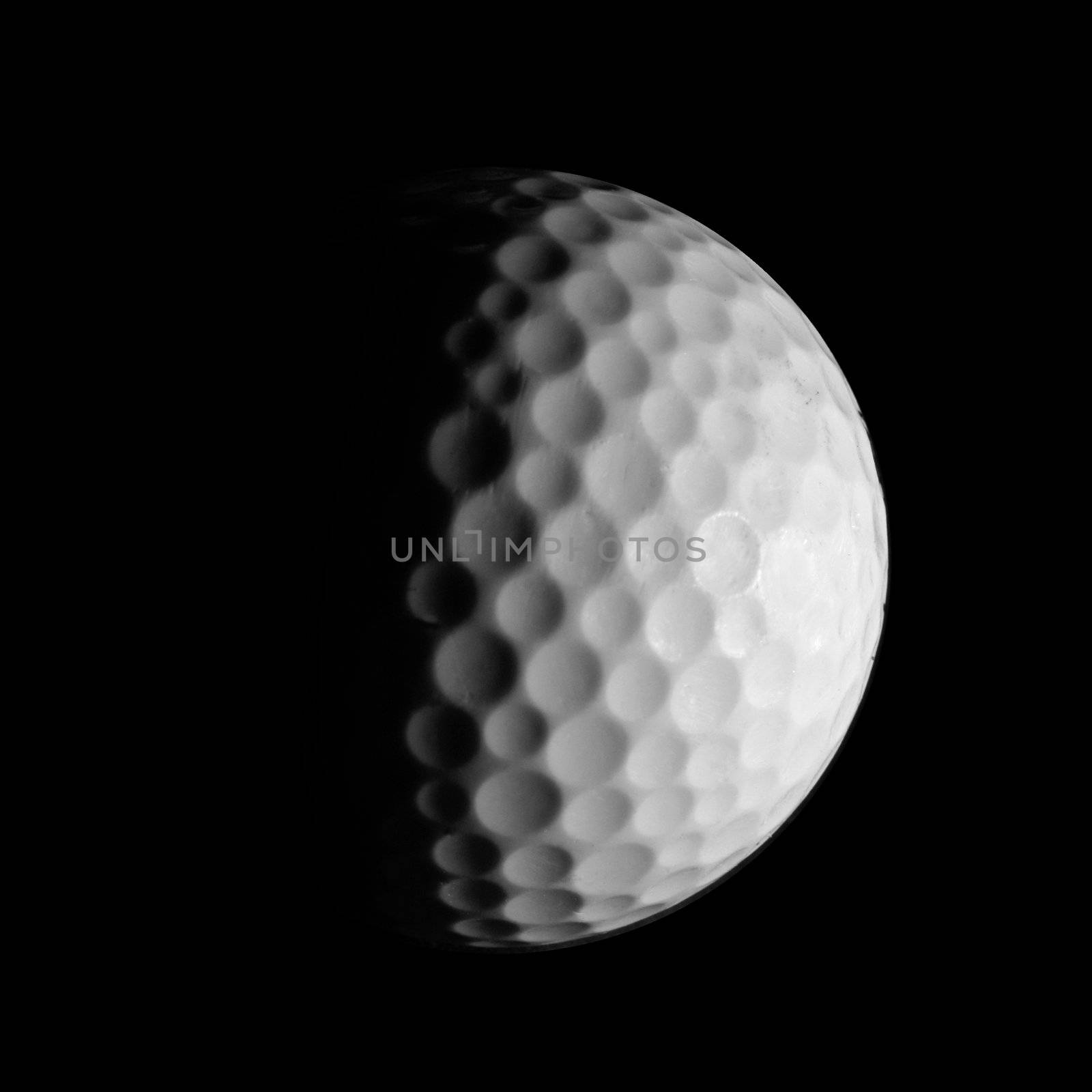 A macro shot of a golf ball highlighting the details of the surface.