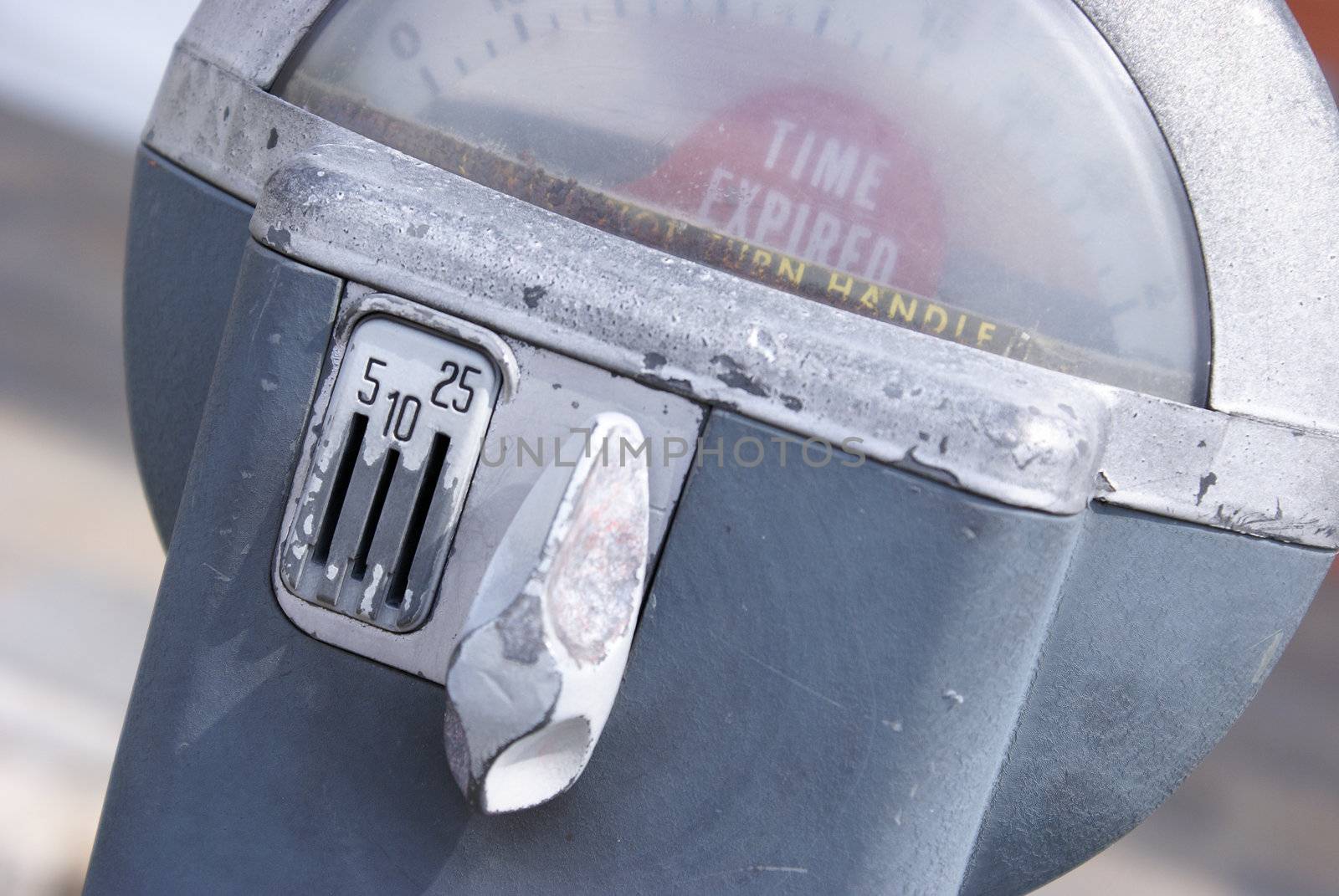 A macro shot of an older style parking meter.