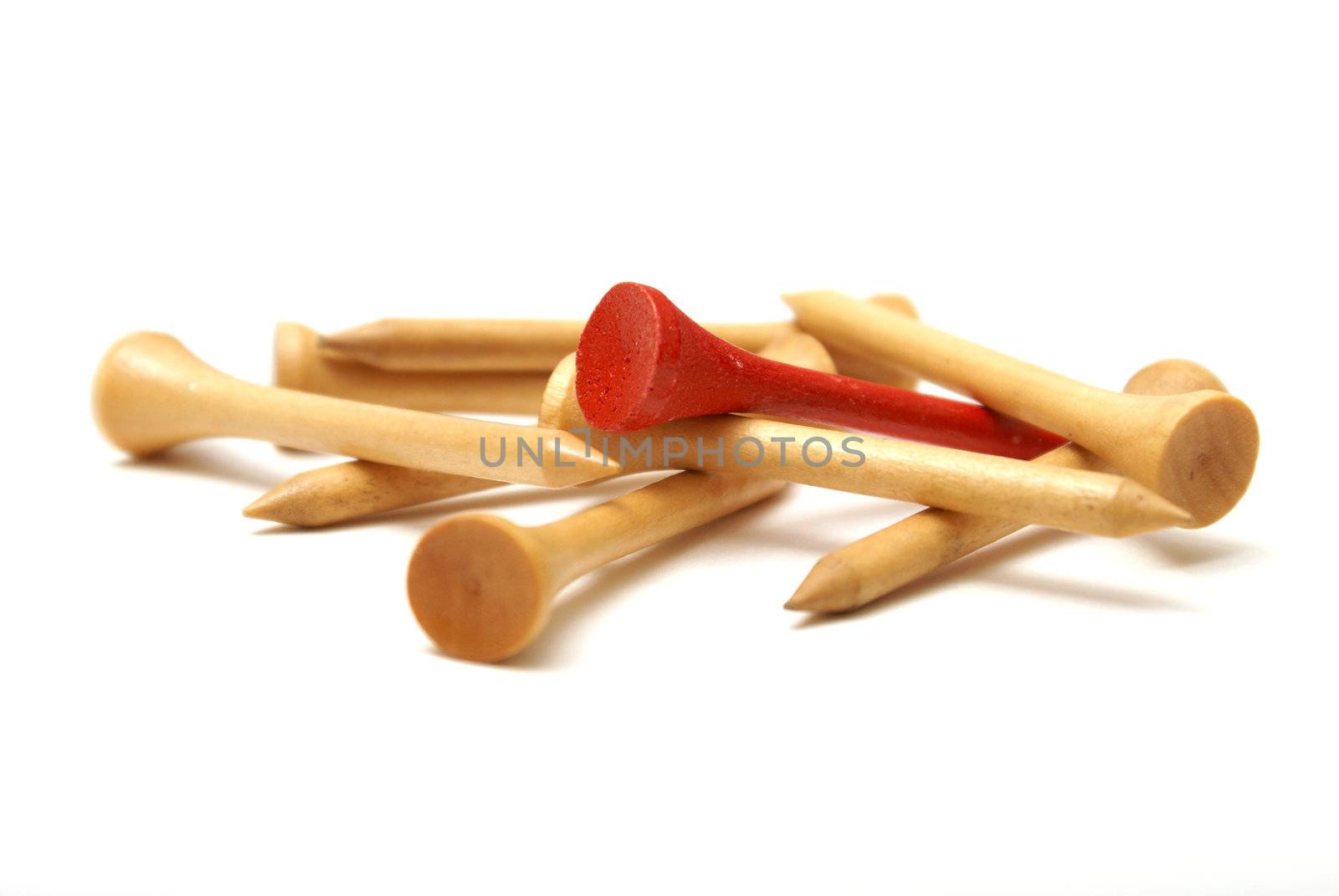 A bunch of golf tees isolated with one red tee in the group.