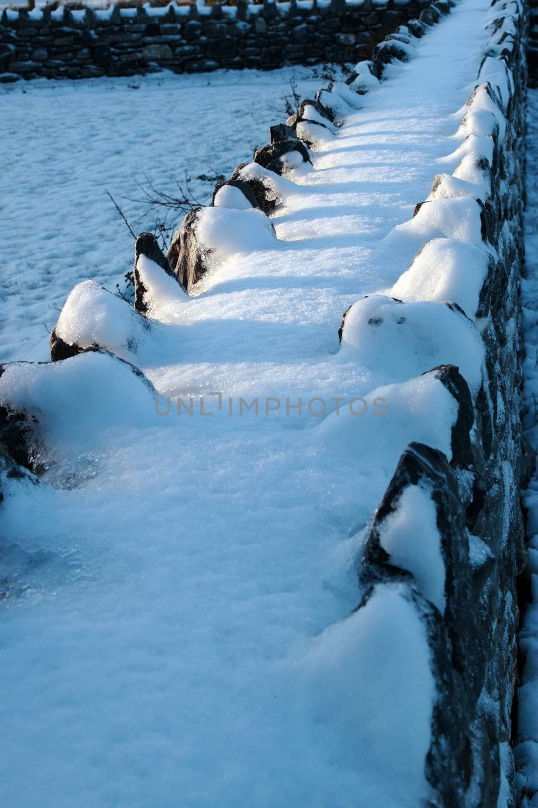 snow covering on a jagged wall in winter