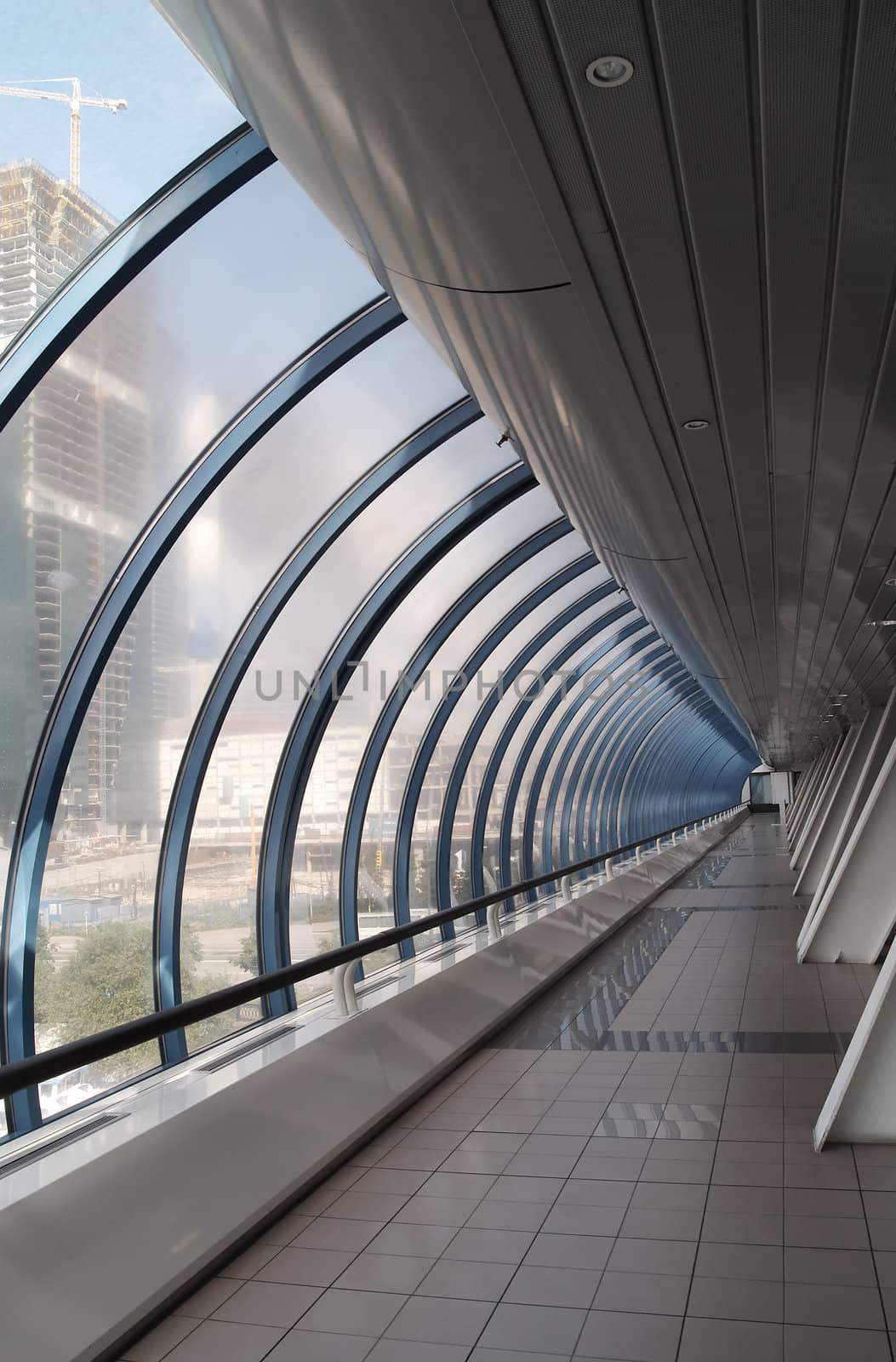 Glass corridor in modern office centre. Vertical image