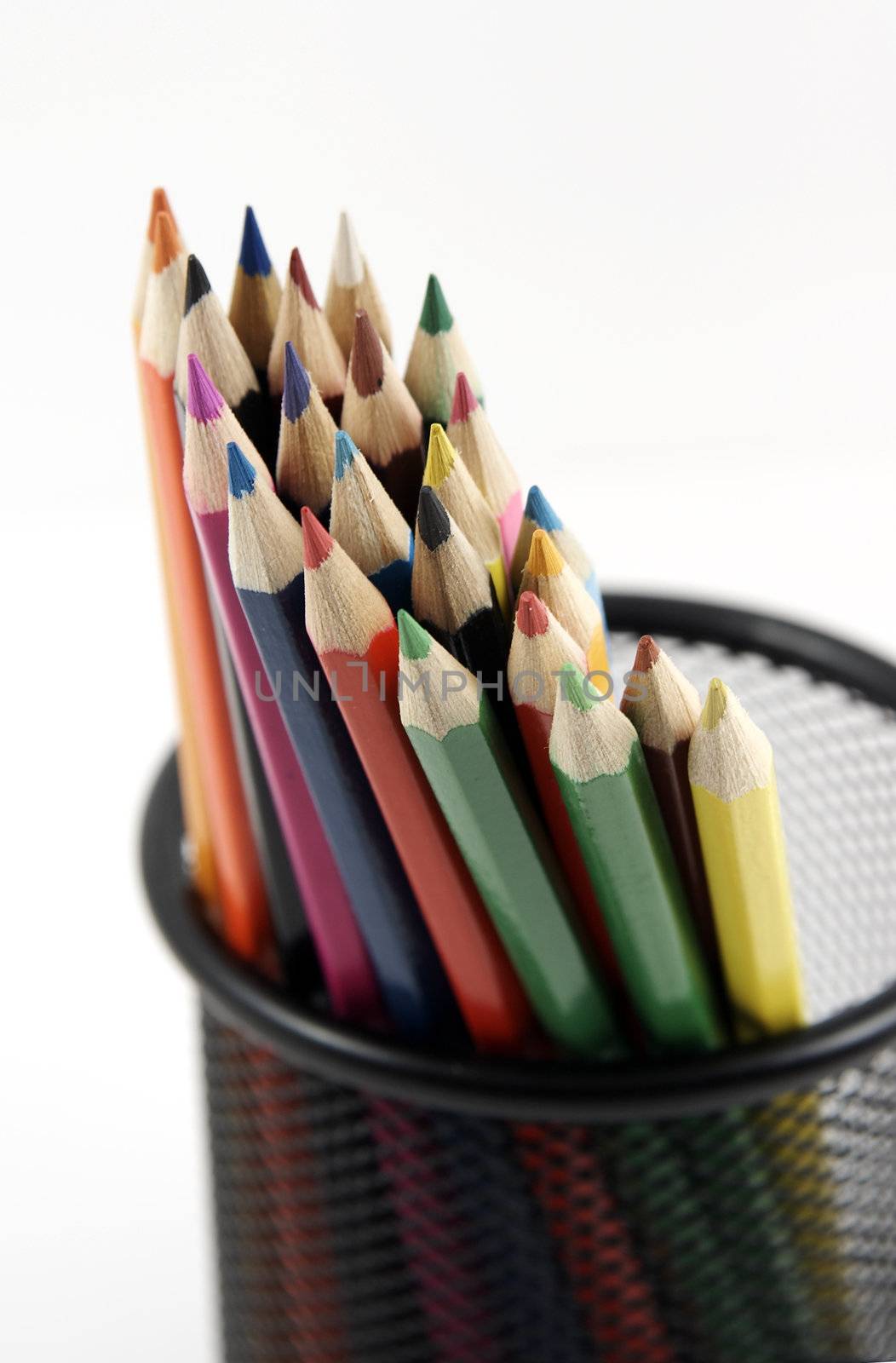 Bunch of colored pencils on white background. Selective focus