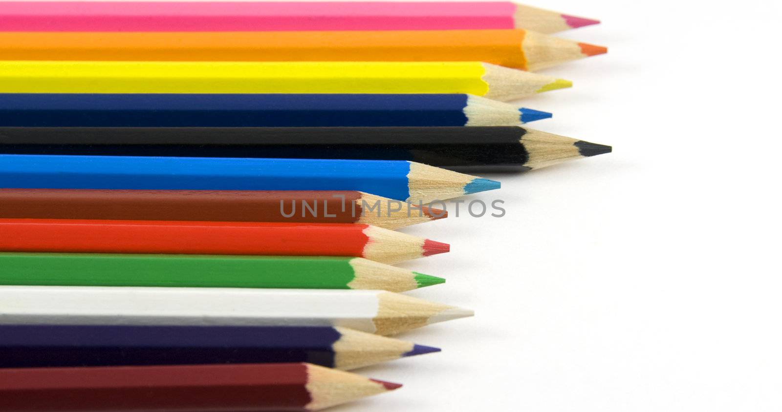 Set of coloured pencils on white background