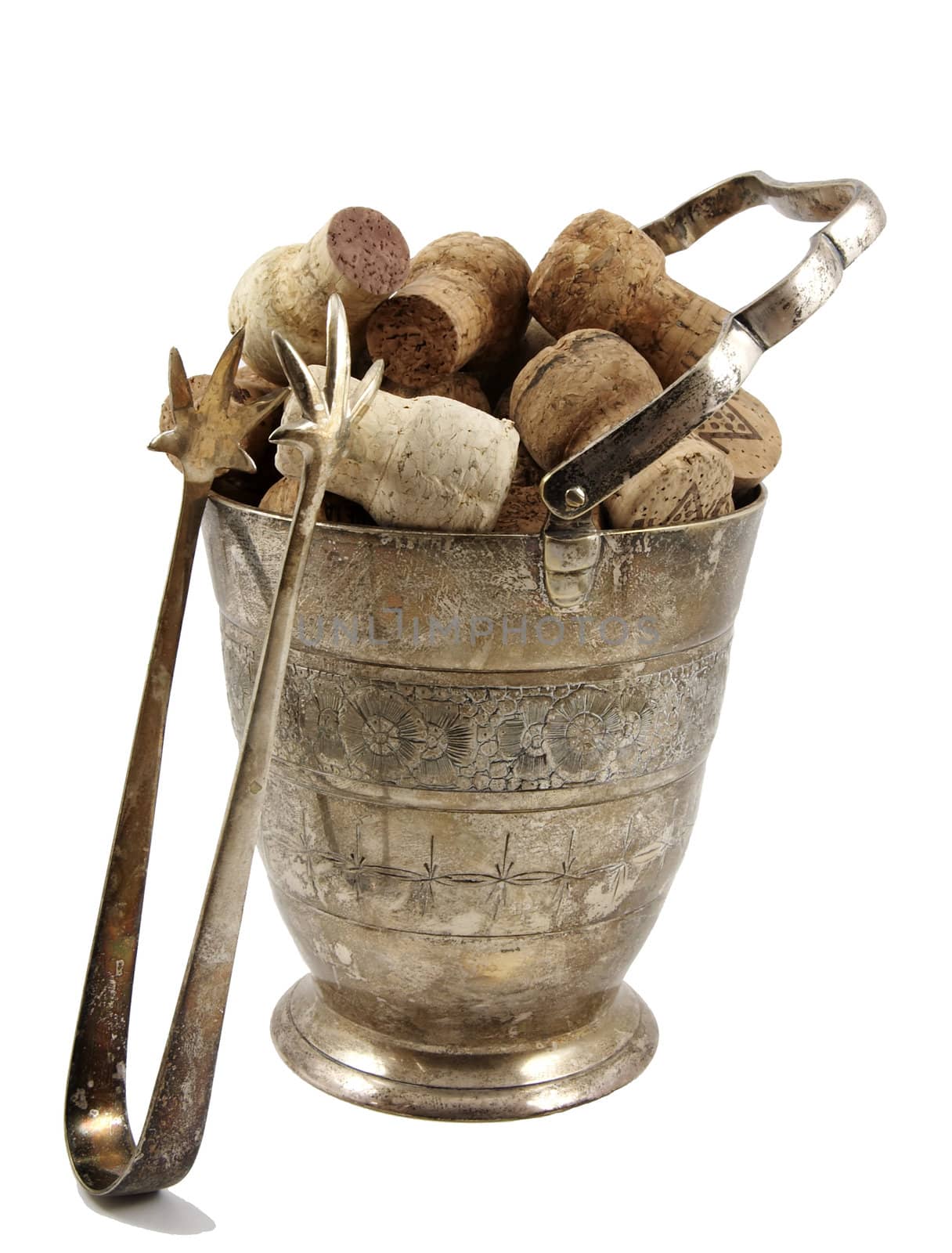 Ice tongs and bucket filled with corks isolated over white background