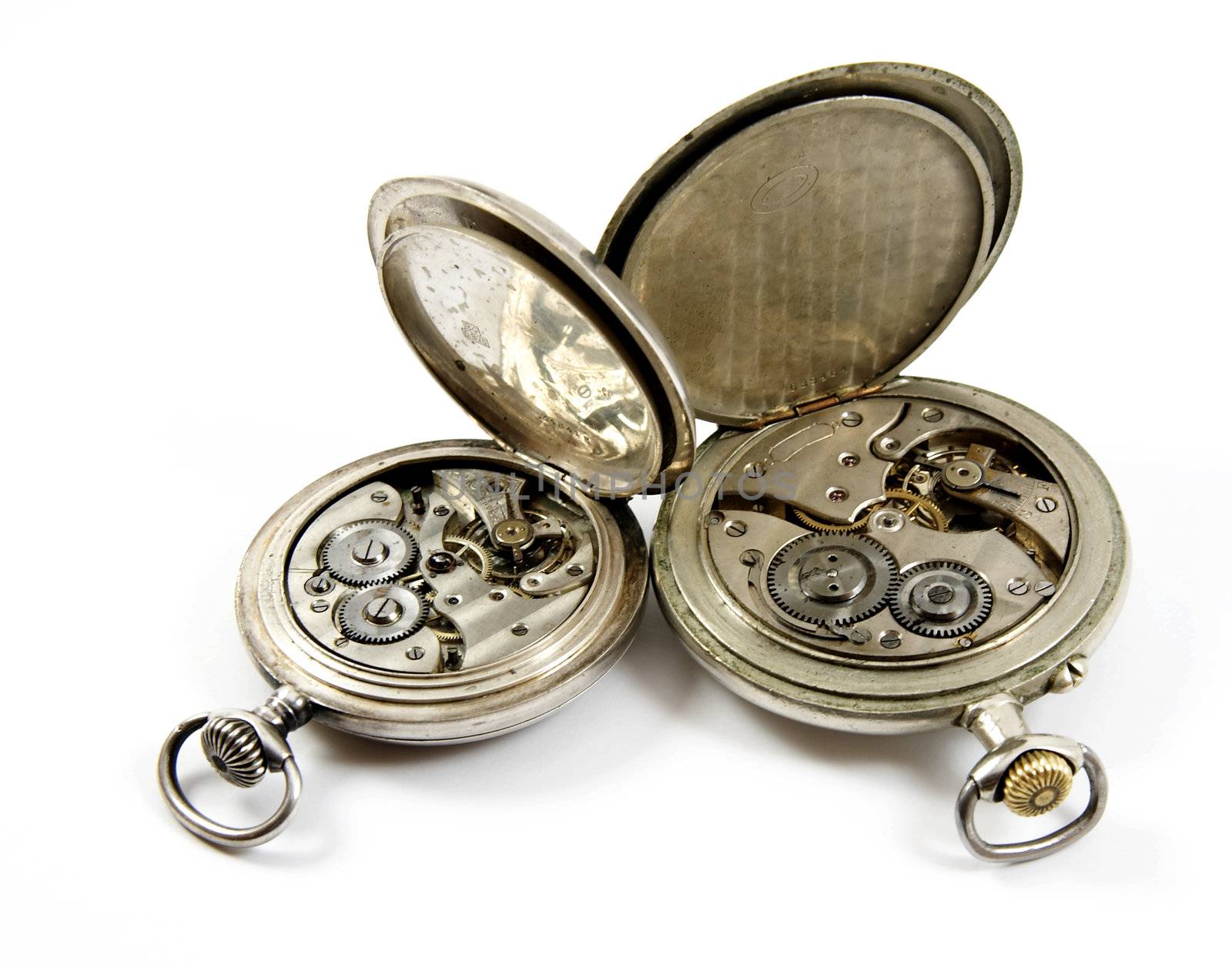 Internal mechanism of two old silver pocket watches isolated over white background