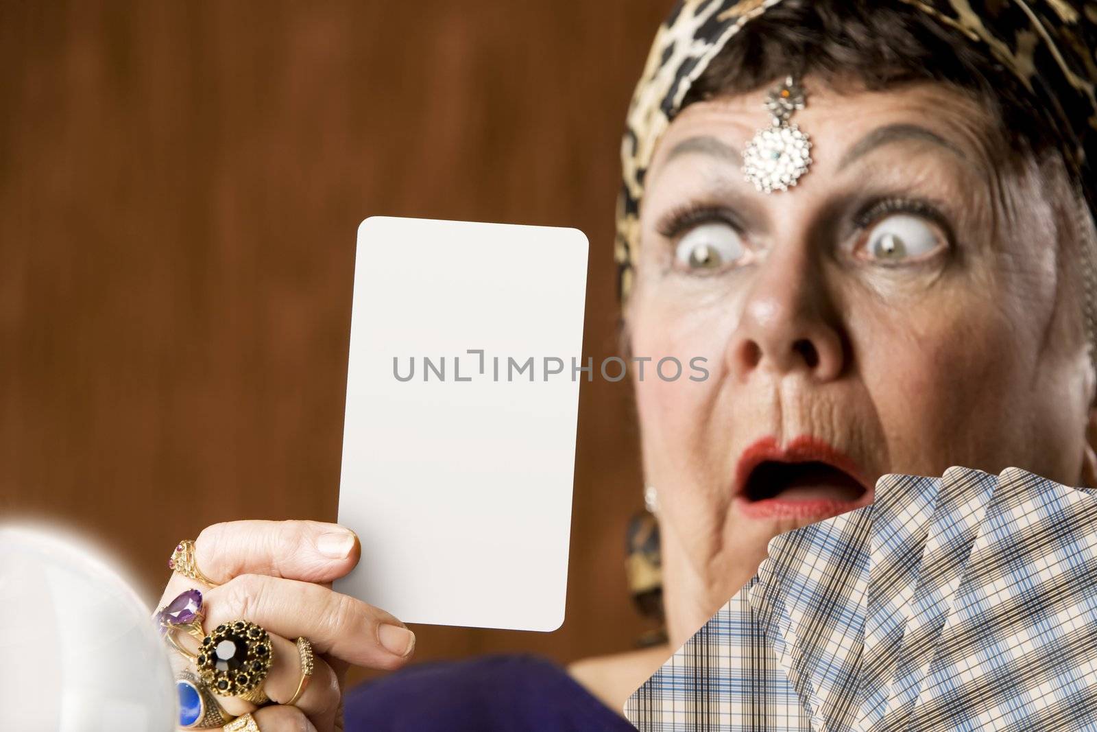 Gypsy fortune teller holding a blank tarot card