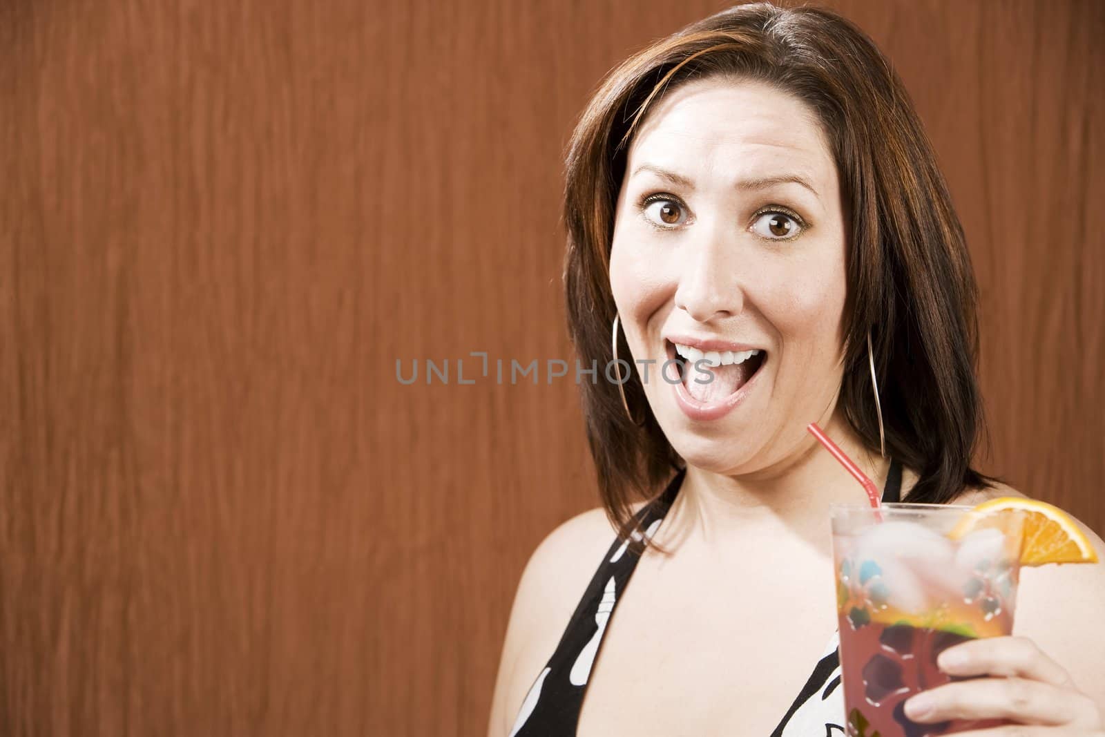 Hispanic woman having fun and holding a drink