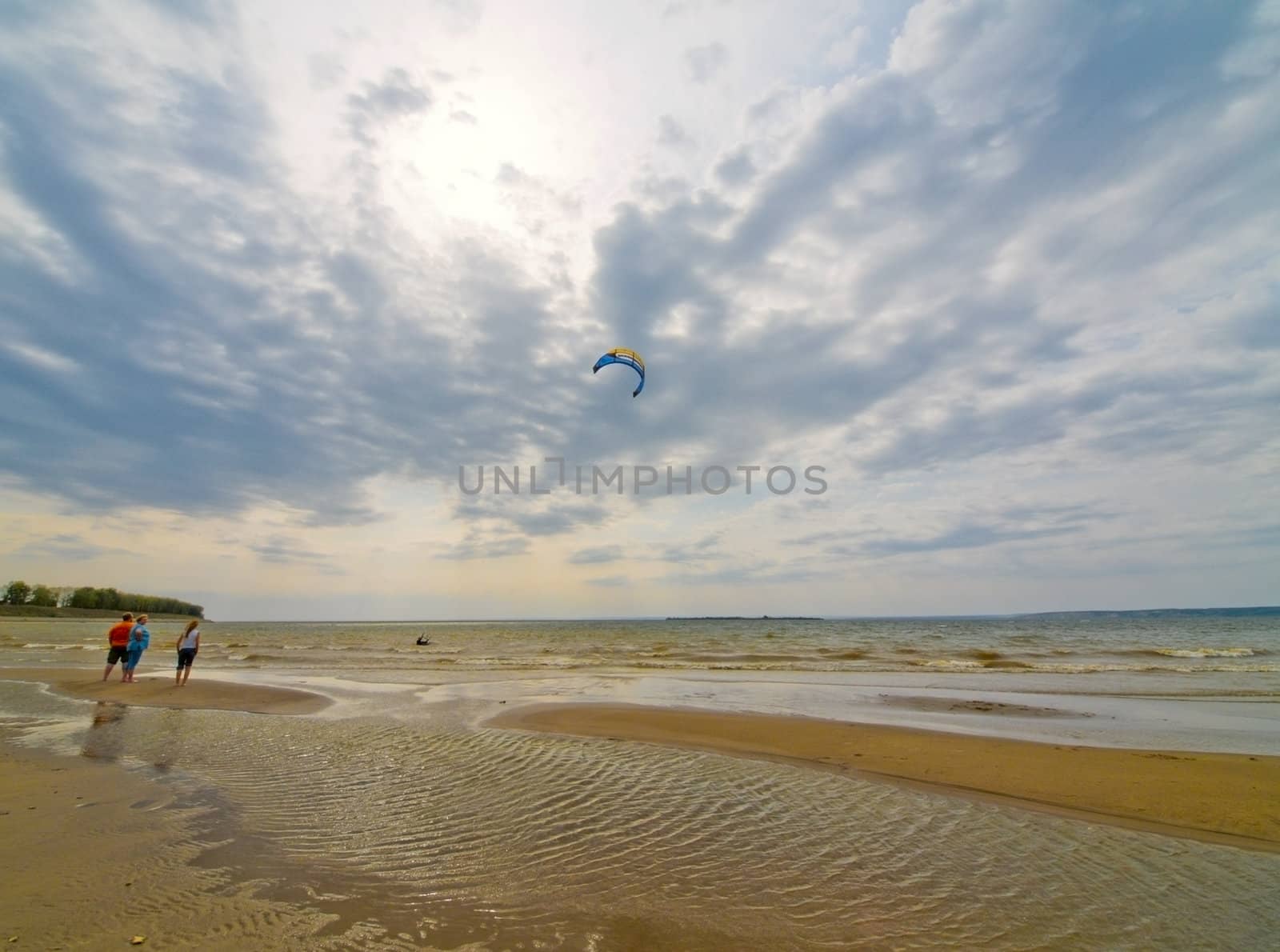 Peoples on a sand-bar beach.