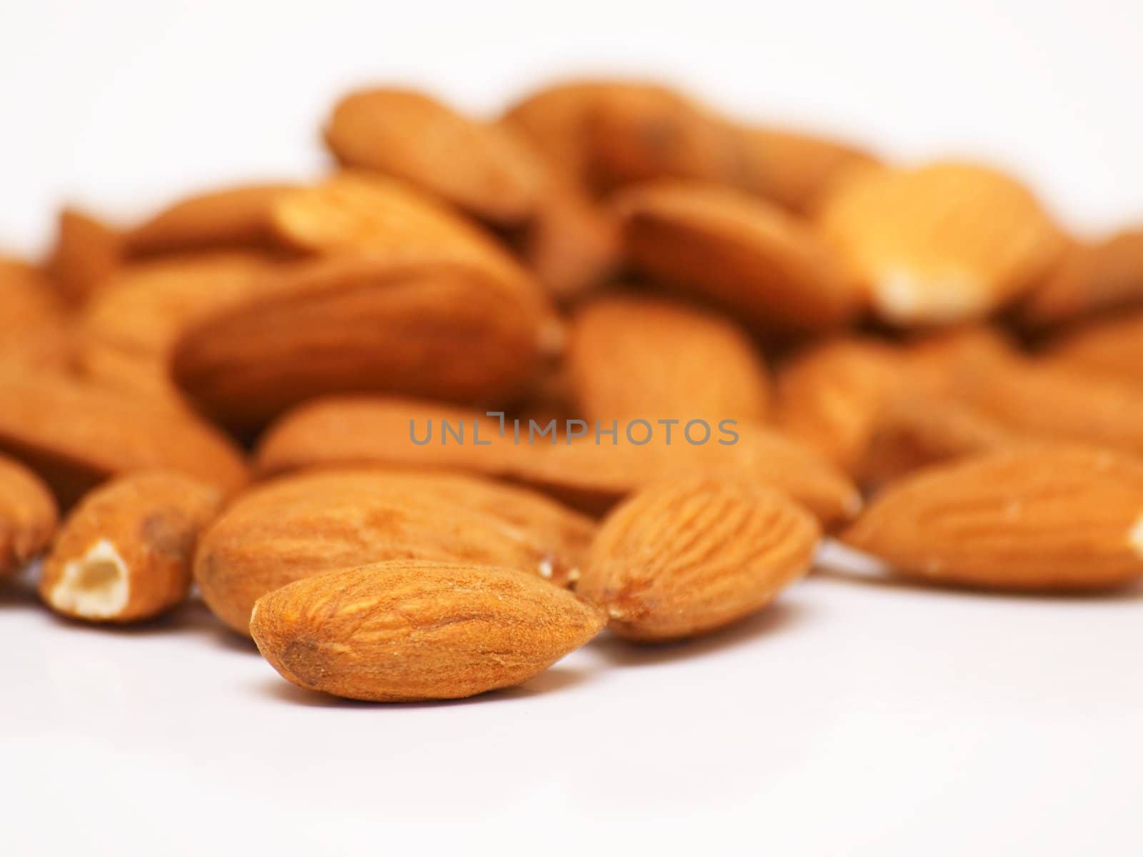 Bunch of almonds laying on top of a white plate