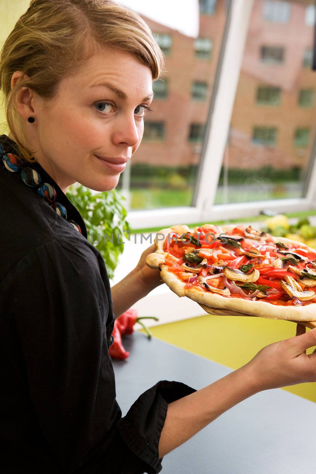 Young Woman with Fresh Pizza by leaf