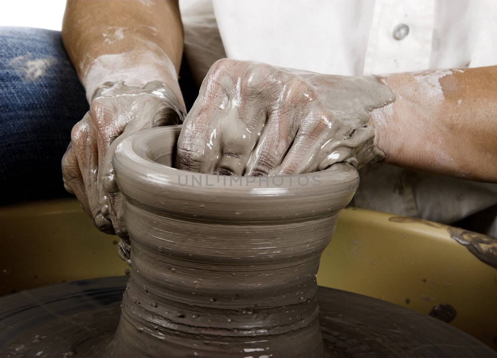 Close-up picture of a potter works a potter's wheel