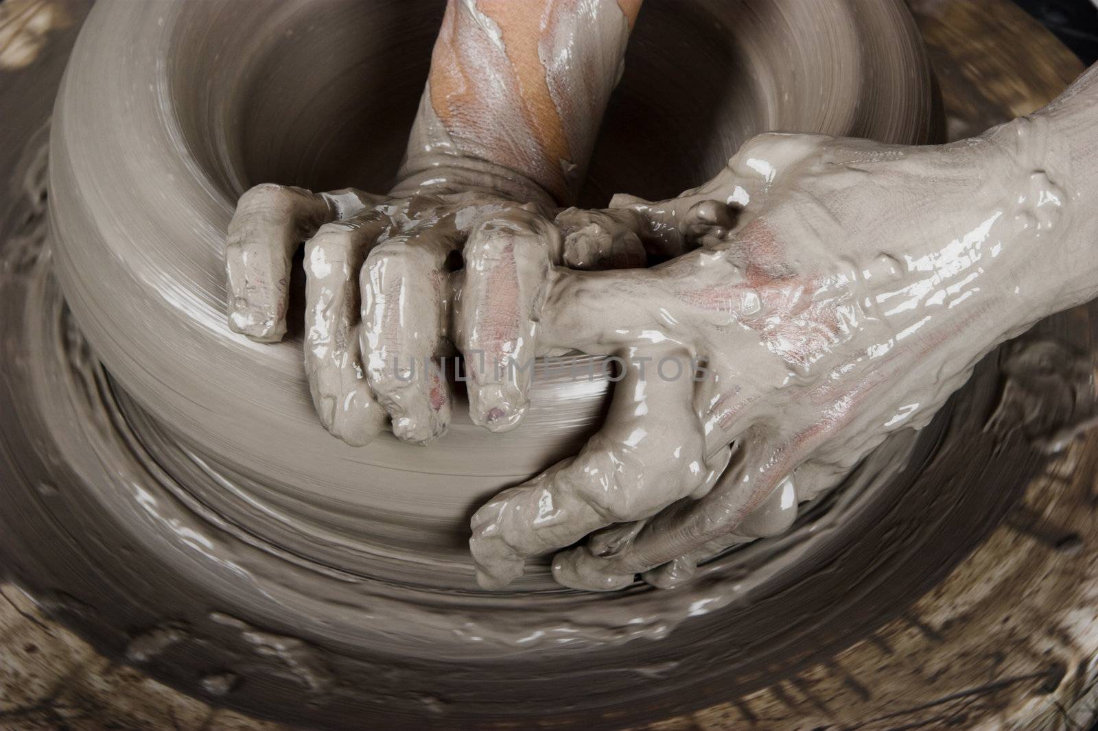 Close-up picture of a potter works a potter's wheel