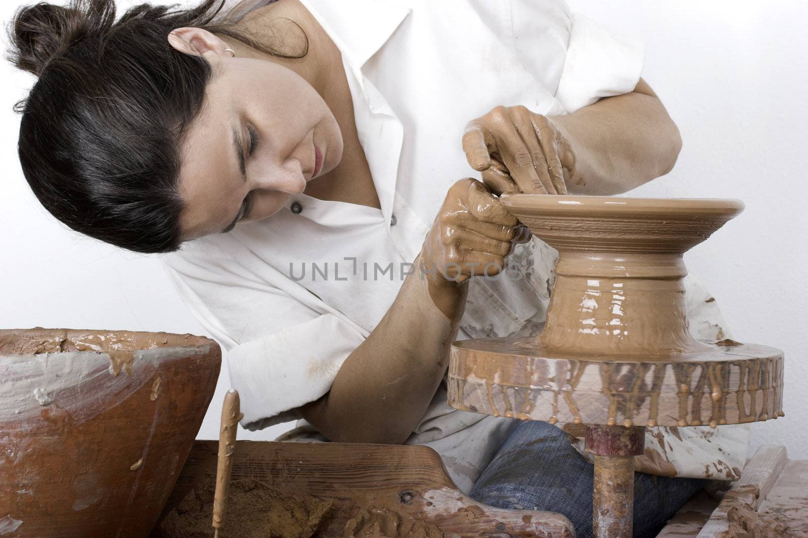 Picture of a potter works a potter's wheel