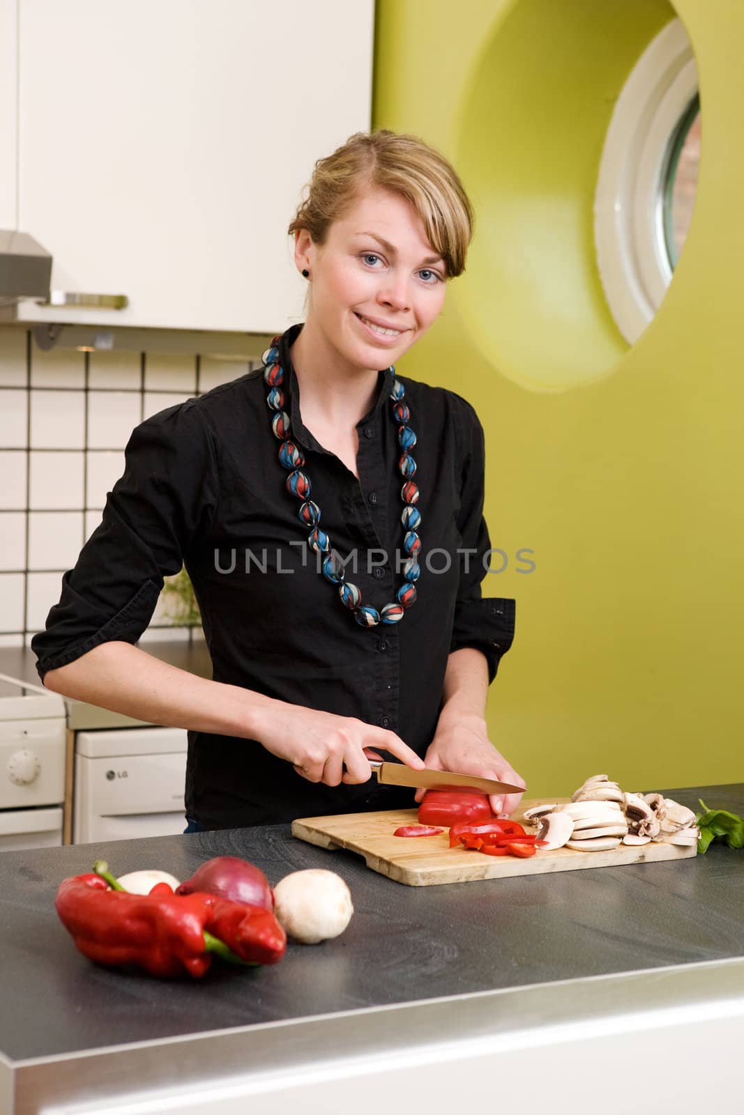 A woman cutting vegetables at home on the counter