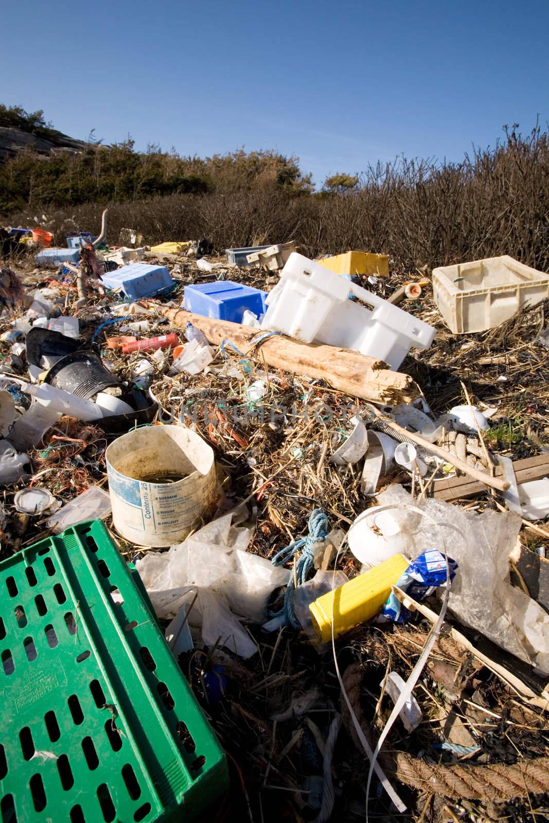 Garbage piled up on the coast of the ocean.