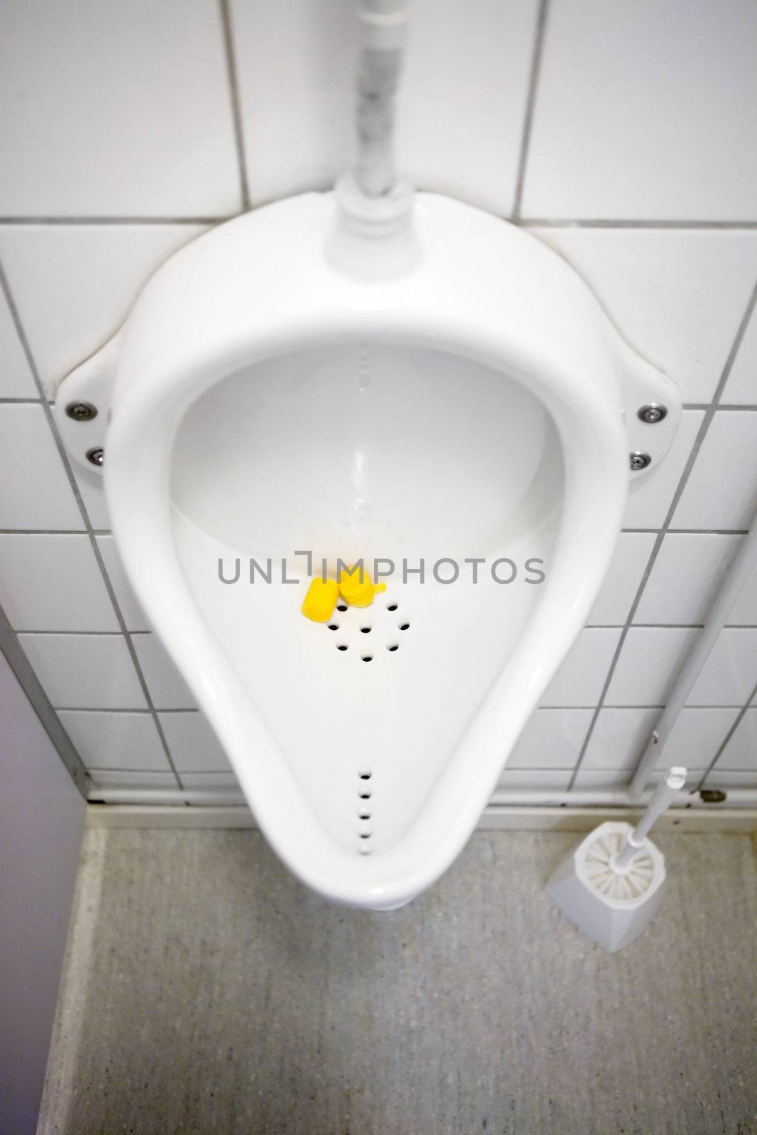 A close up of a public urinal