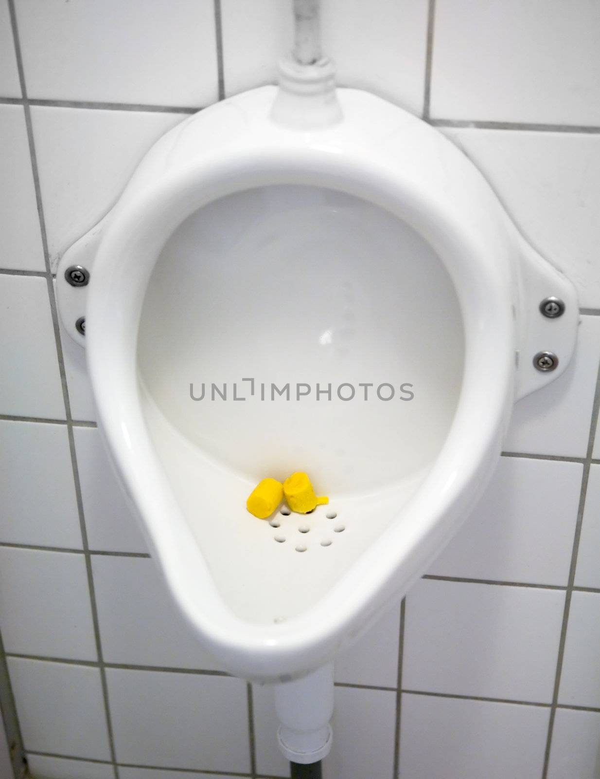 A close up of a public urinal