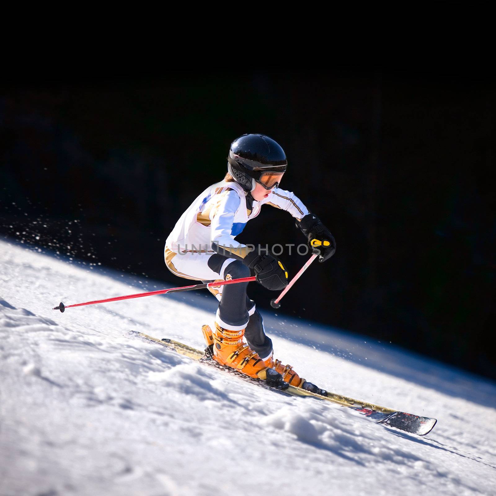 A close up action shot of a downhill skiier