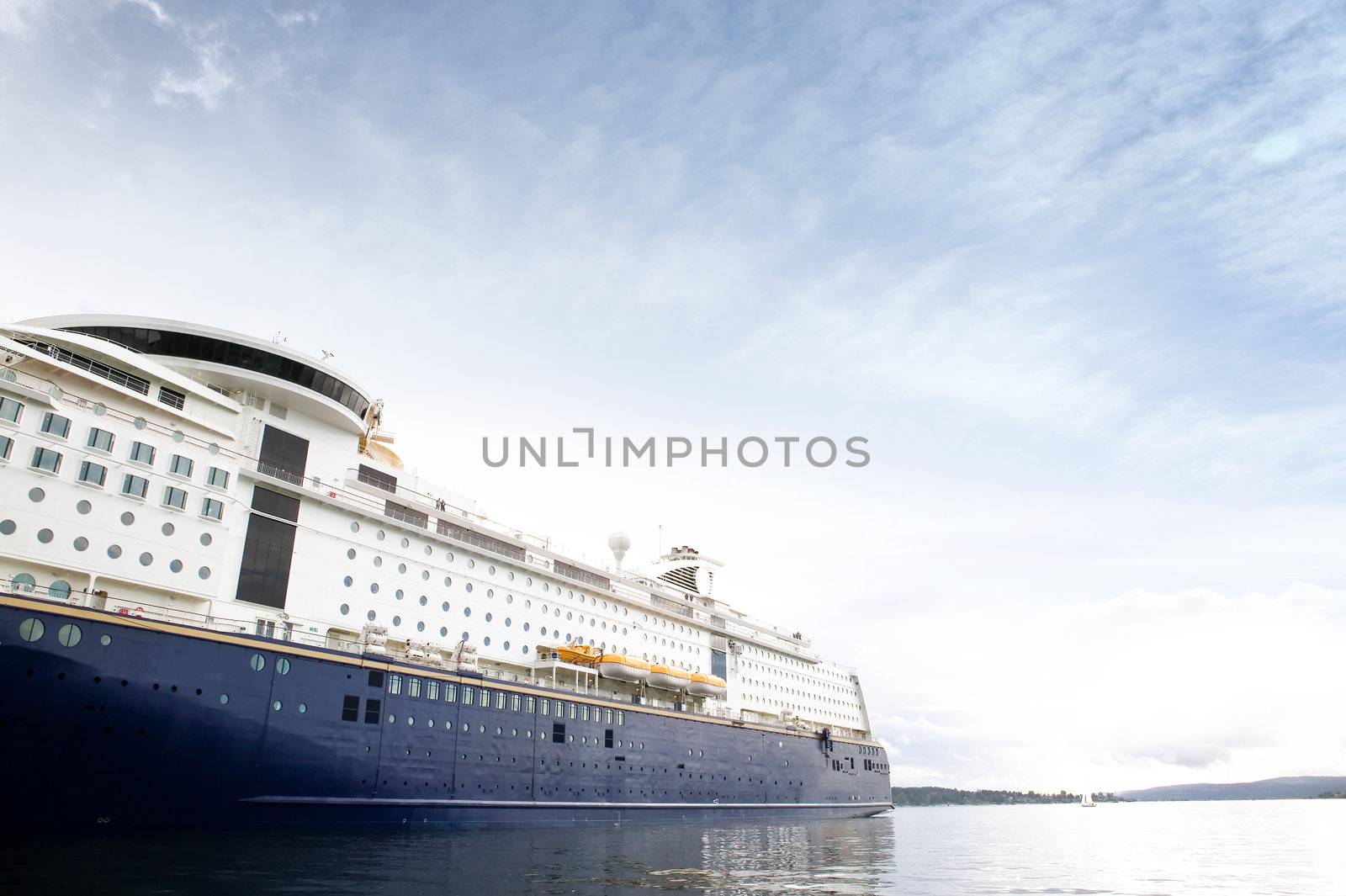 A cruise ship at dock against a blue sky