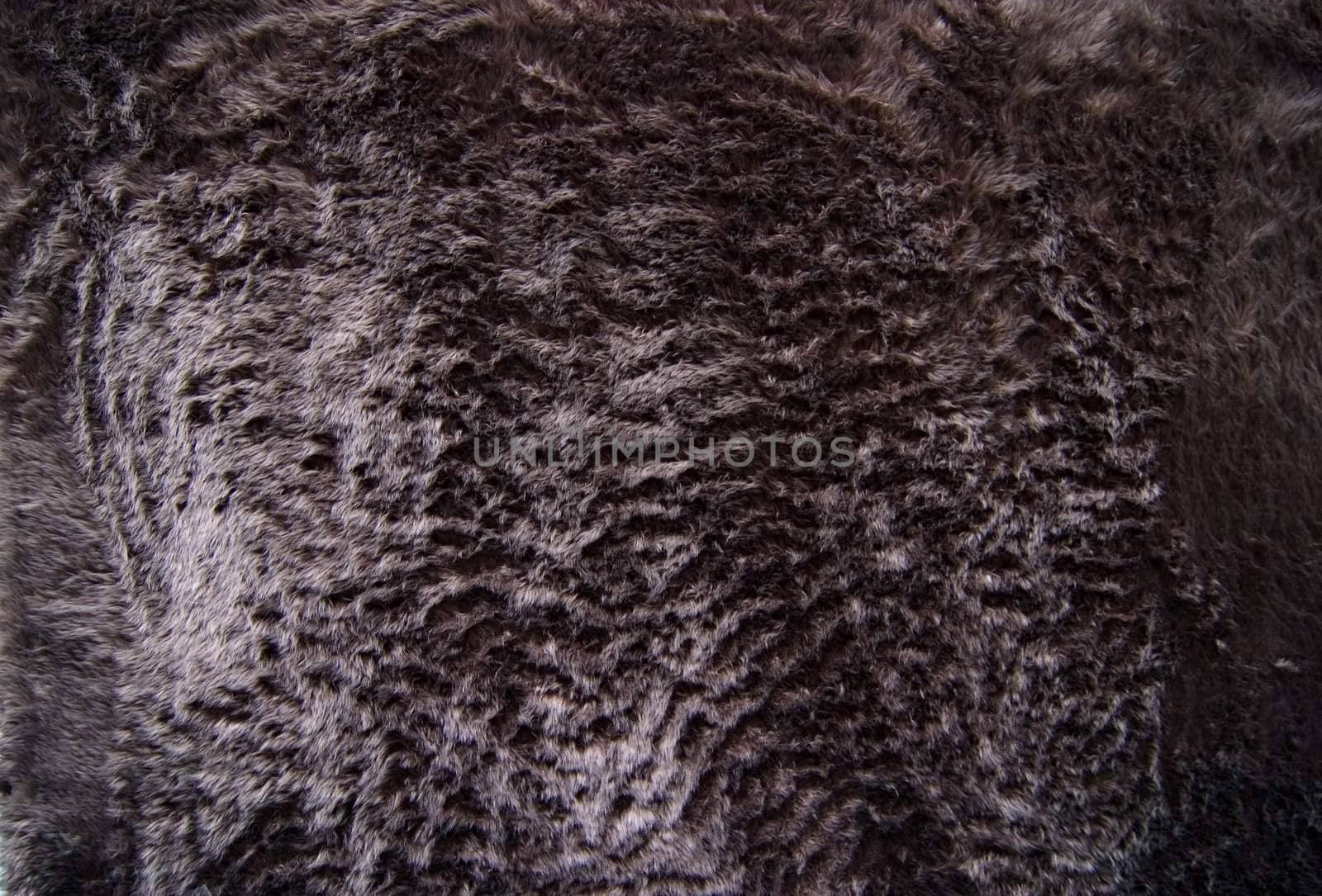 A black fun fur textile texture image.