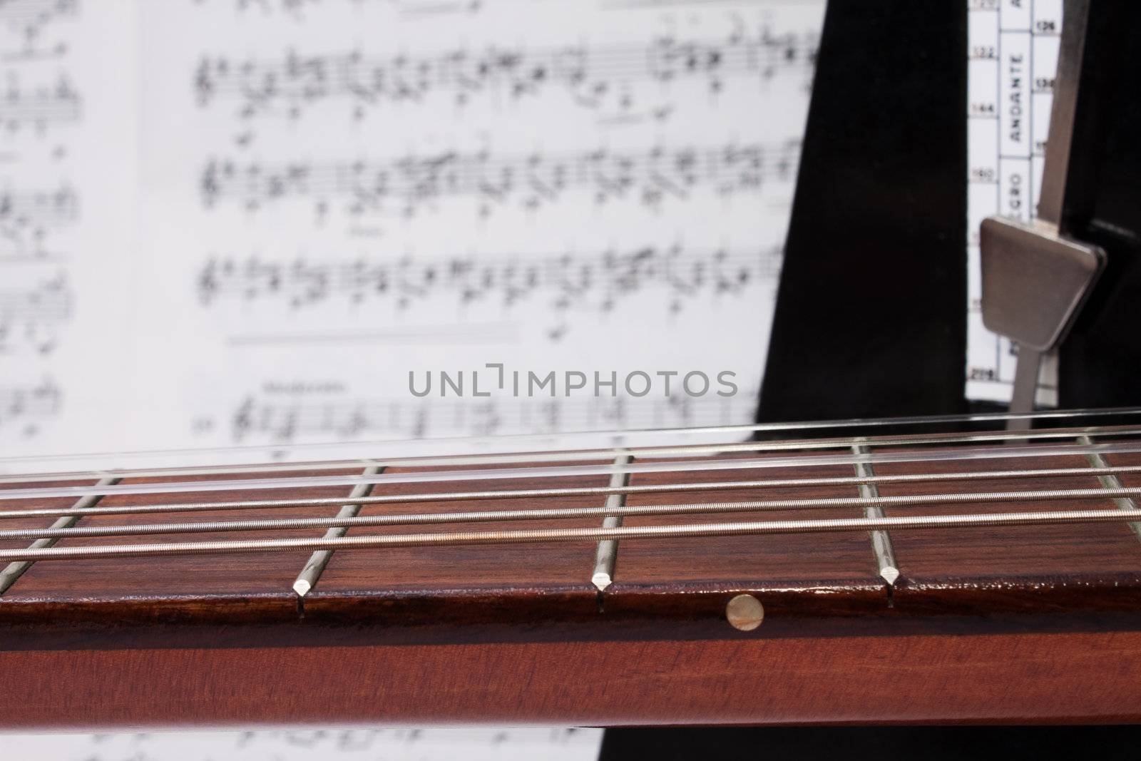 Closeup Classical Acoustic Guitar Neck, Nnotes and Metronome