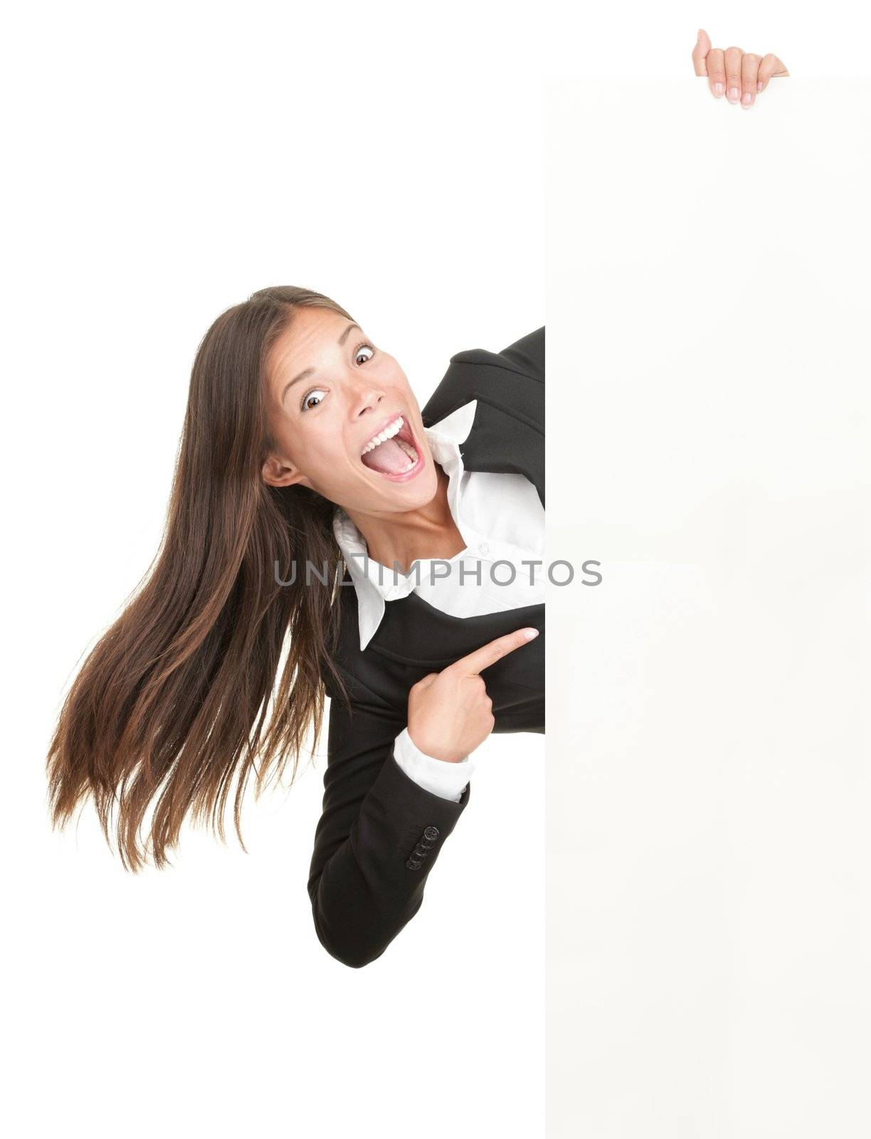 Excited woman pointing at sign. Businesswoman screaming of joy is holding blank billboard placard and pointing at empty copy-space. Isolated on white background.