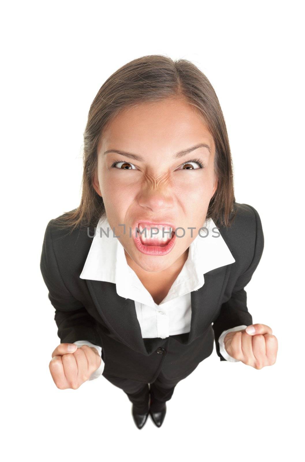 Angry businesswoman isolated. Funny image of young asian business woman upset looking at the camera. Isolated on white background.