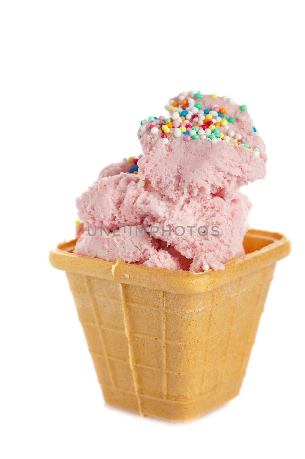 Strawberry icecream in small cookie cup with sprinkles on top