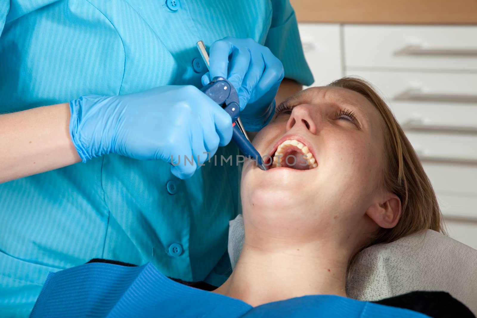 Patient at the dentist looking painful
